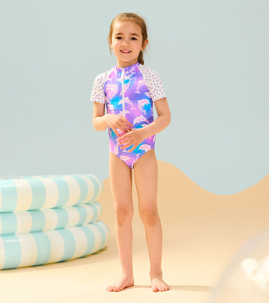 Colorful one-piece rashguard featuring dolphin print and short sleeves, ideal for beach or pool activities.