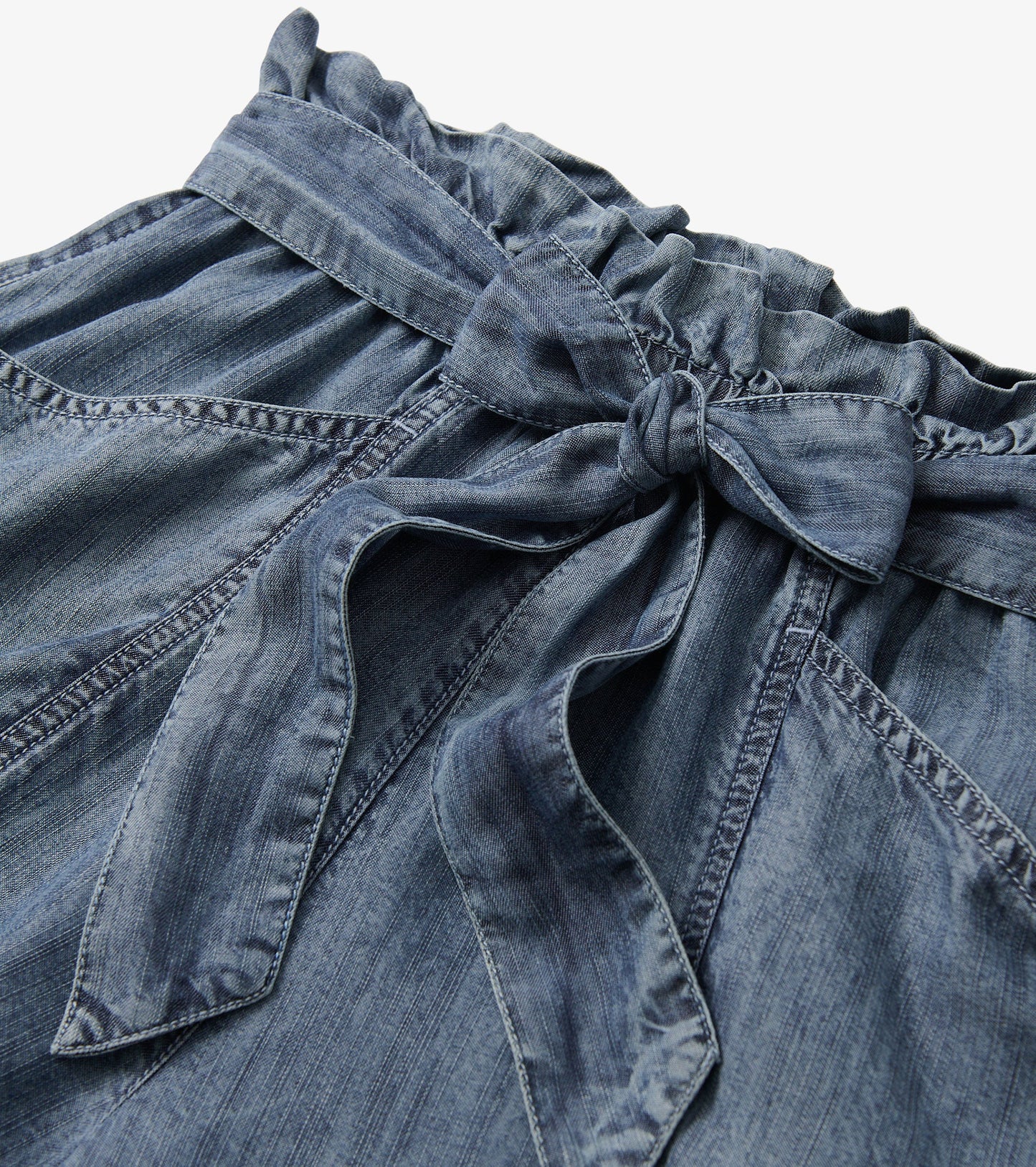 Blue acid wash shorts featuring a ruffled waistband and a tied belt detail.