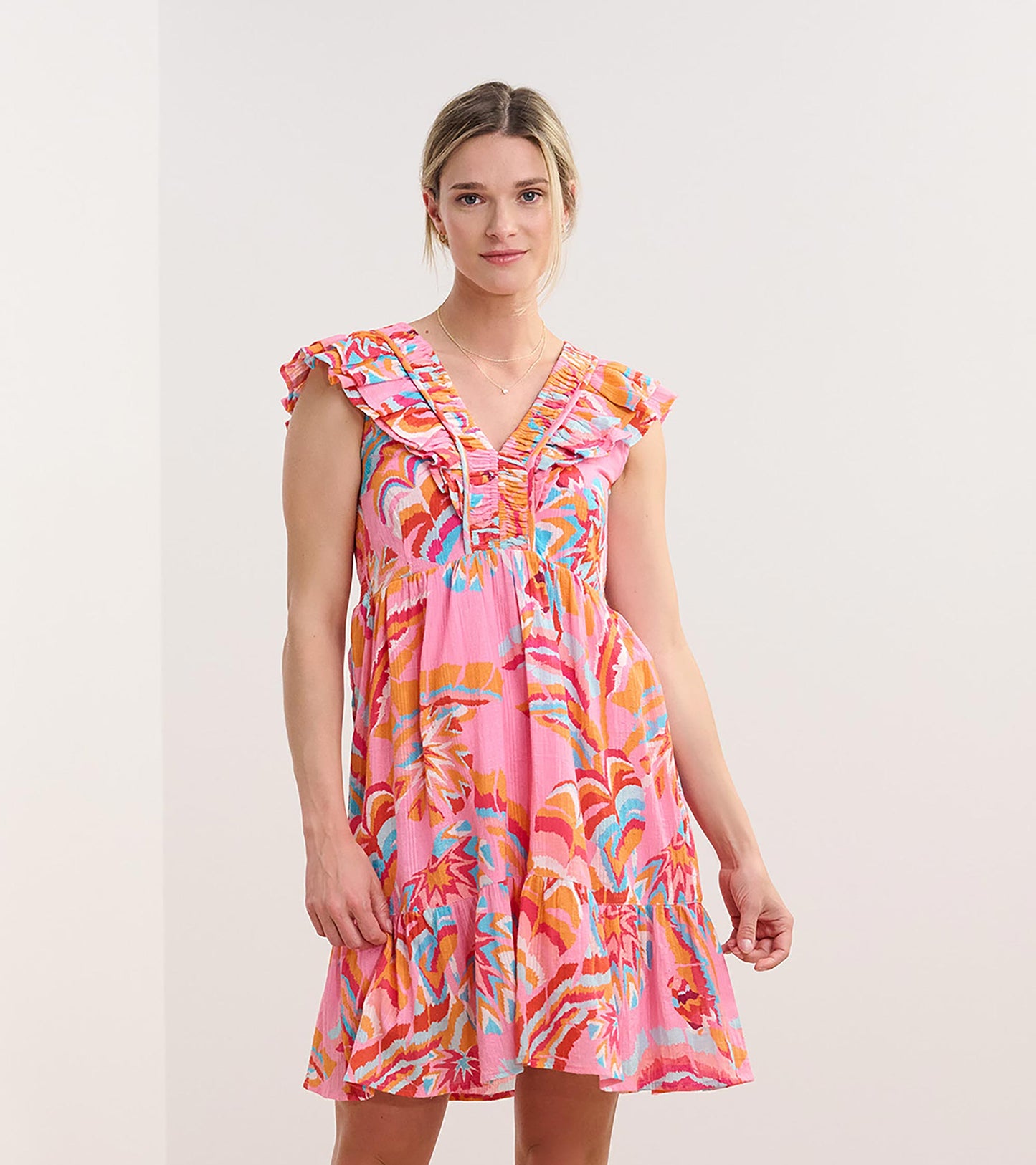Pink ruffle sleeve dress featuring a vibrant palm print in orange and blue, with a tiered skirt and a relaxed fit.