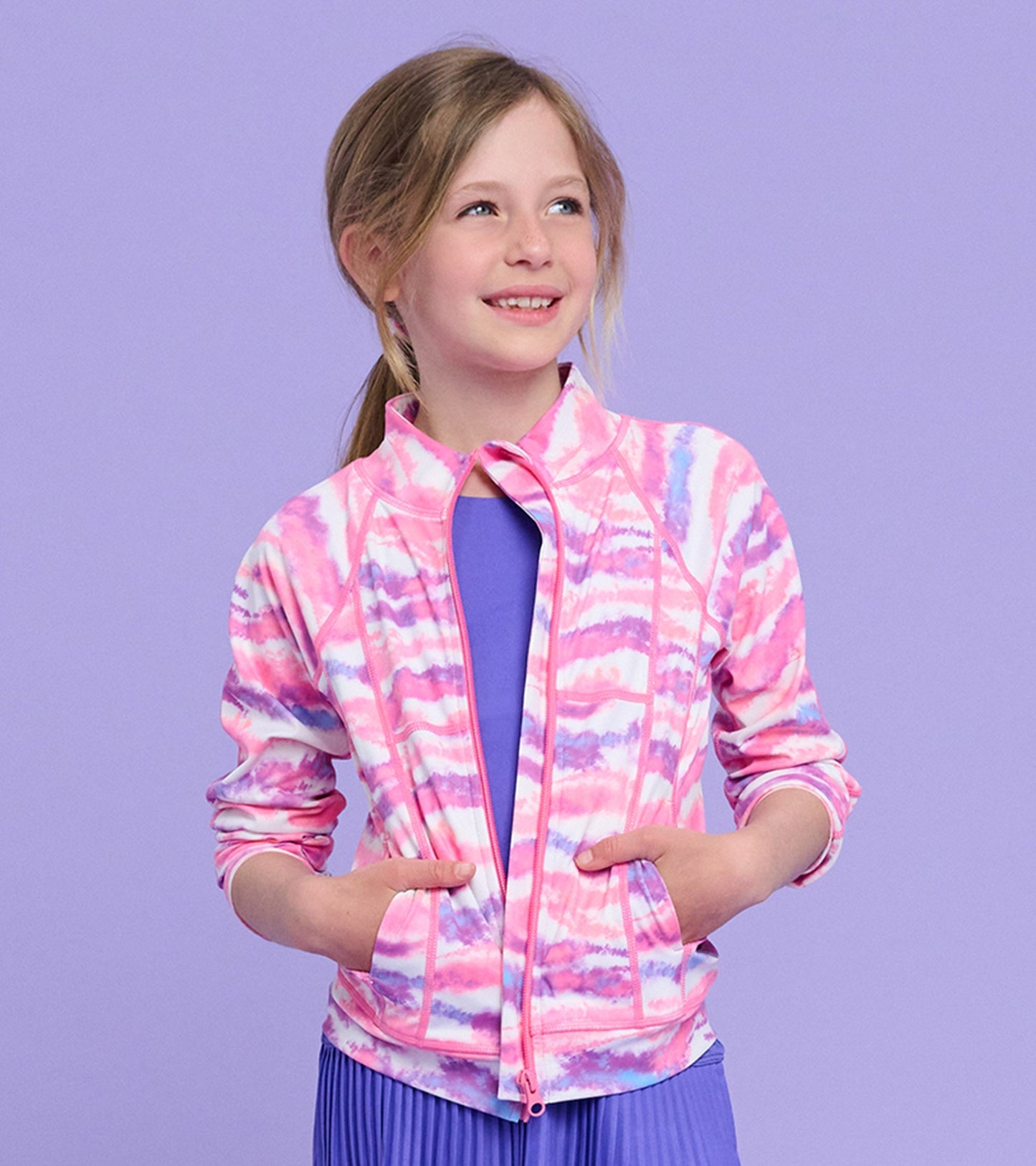 Girls' active jacket in pink and purple ombre tie-dye pattern, featuring a zip front and side pockets.