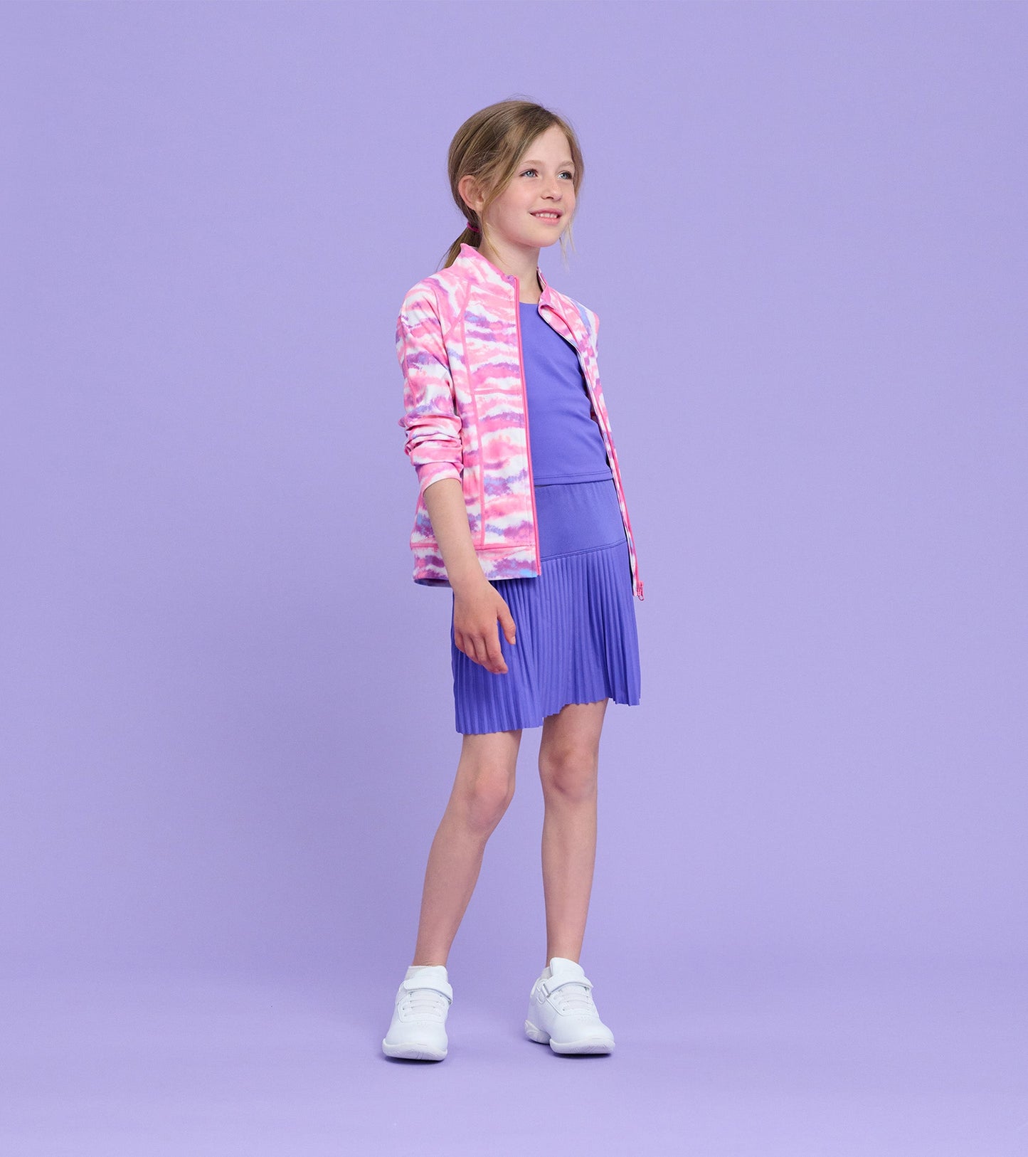 Girls' active jacket in pink and purple ombre pattern, featuring a zip front and lightweight design, paired with a purple dr…