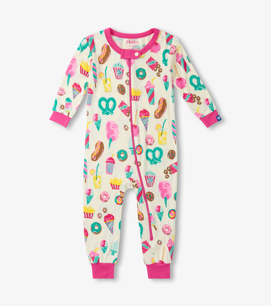 Cream-colored sleeper with colorful carnival treats pattern, featuring pink trim and snap closure. Suitable for baby girls.