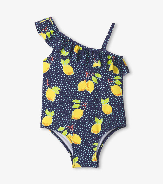 Navy swimsuit with yellow lemon print and ruffle trim, featuring one shoulder strap and polka dot accents.