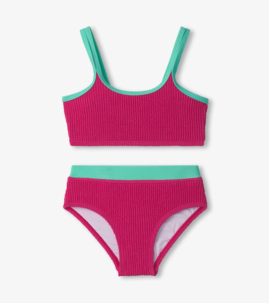 Fuchsia purple bikini set with textured fabric, featuring a cropped top and matching high-waisted bottoms with aqua accents.