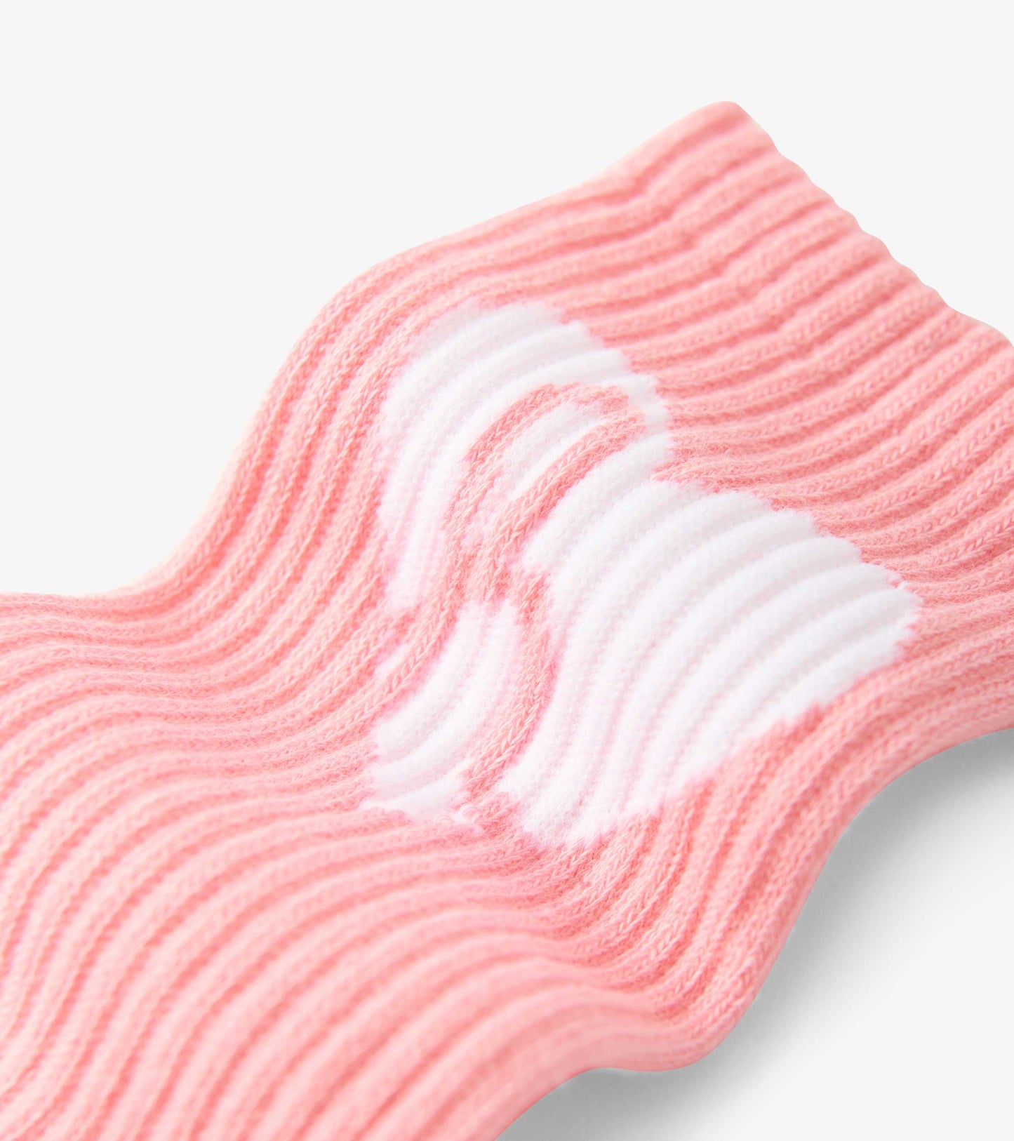 Pink ribbed tube socks featuring a white heart pattern, suitable for kids aged 2-12.