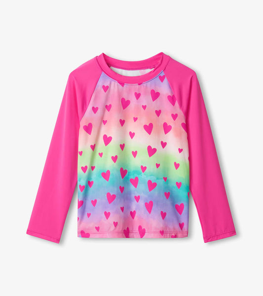 Long sleeve rashguard featuring a colorful gradient with pink hearts, ideal for sun protection during water activities.