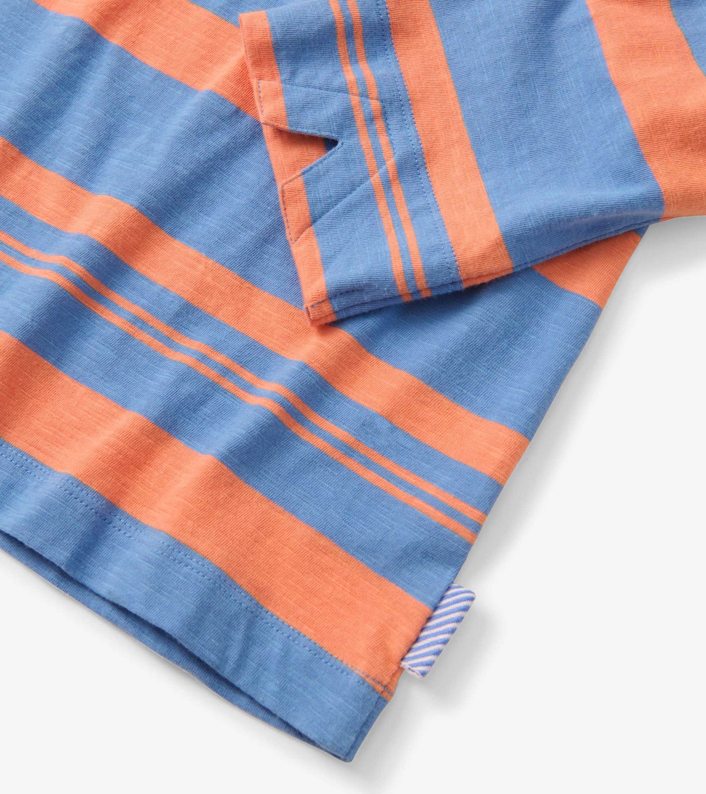 Blue and melon striped fabric with short sleeves, featuring a relaxed fit and a tag on the side.