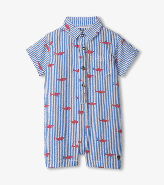 Blue and white striped woven romper featuring red shark silhouettes, short sleeves, and a button-down front.