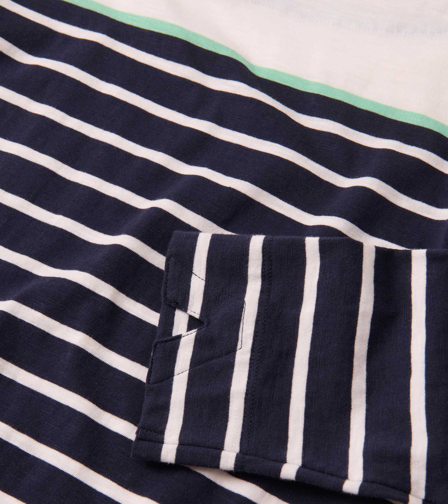 Navy and white striped long-sleeve top with a mint green accent near the neckline.