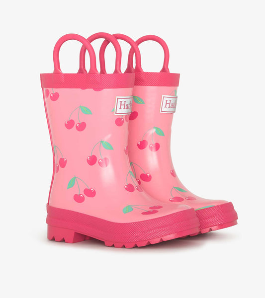 Pink rain boots featuring a cherry pattern, with two handles for easy wear, designed for kids.