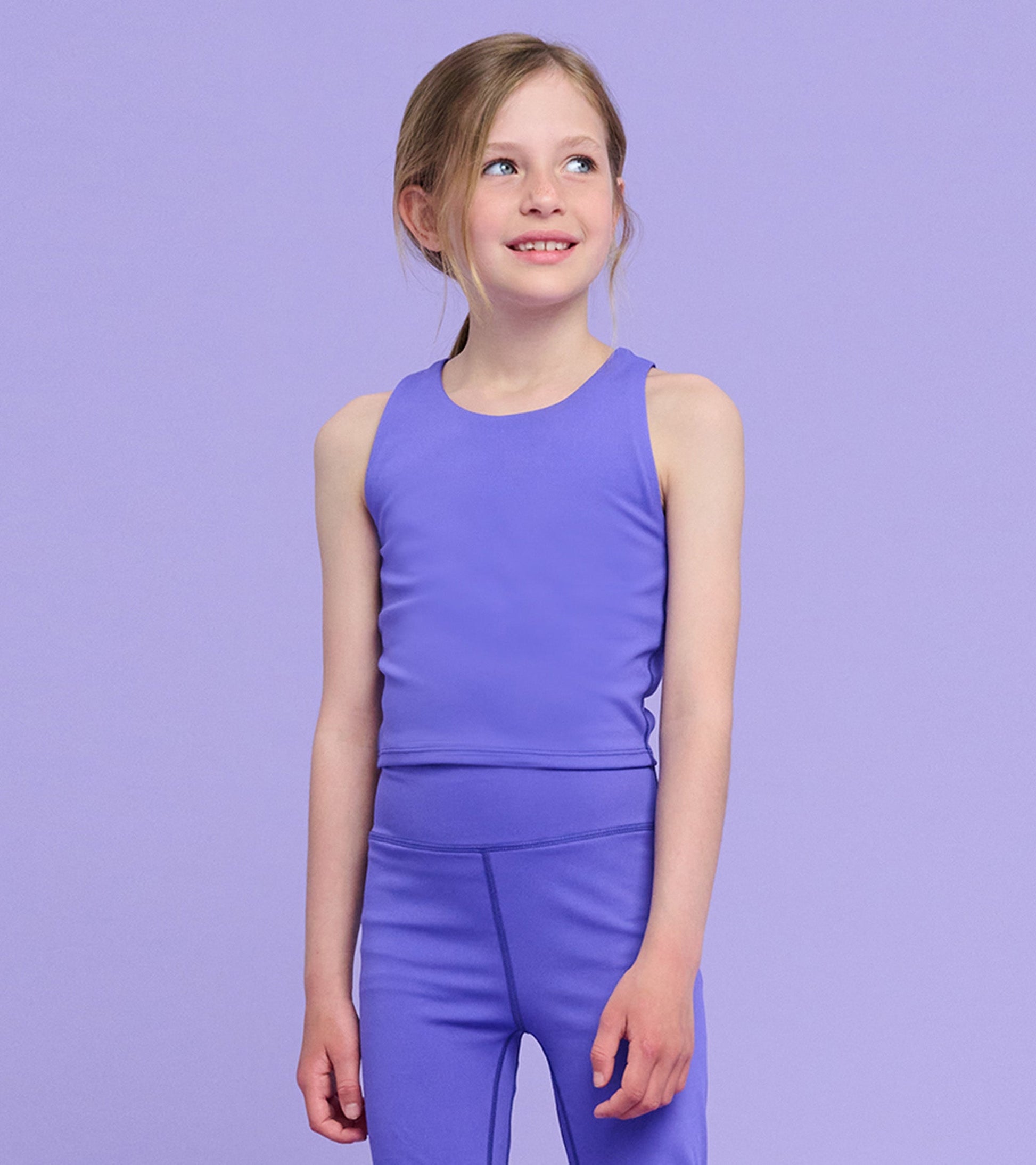 Purple sleeveless tank top for girls, made from soft material, featuring a simple design.