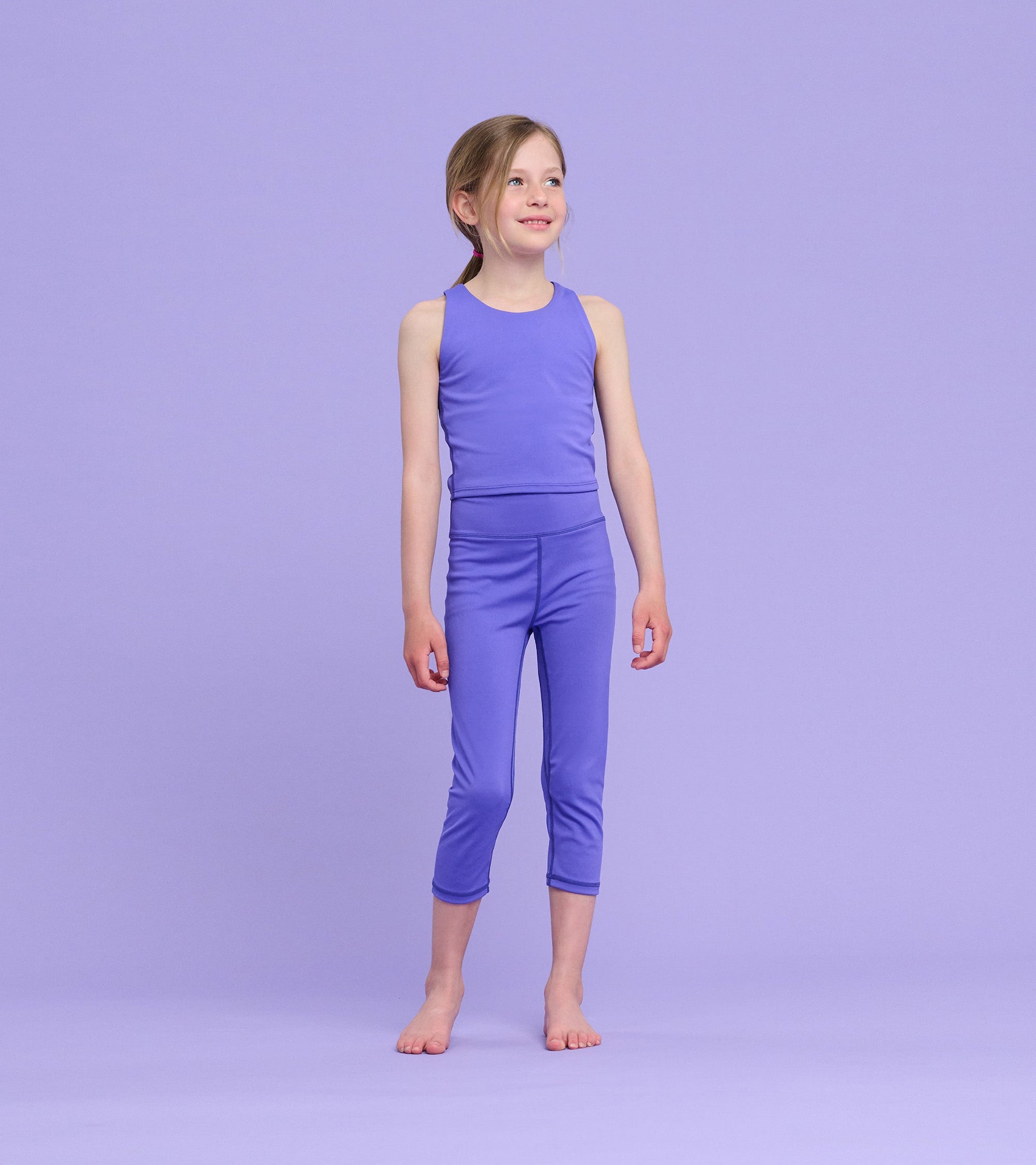 Purple tank top for girls, featuring a sleeveless design and a comfortable fit, suitable for casual wear or active play.