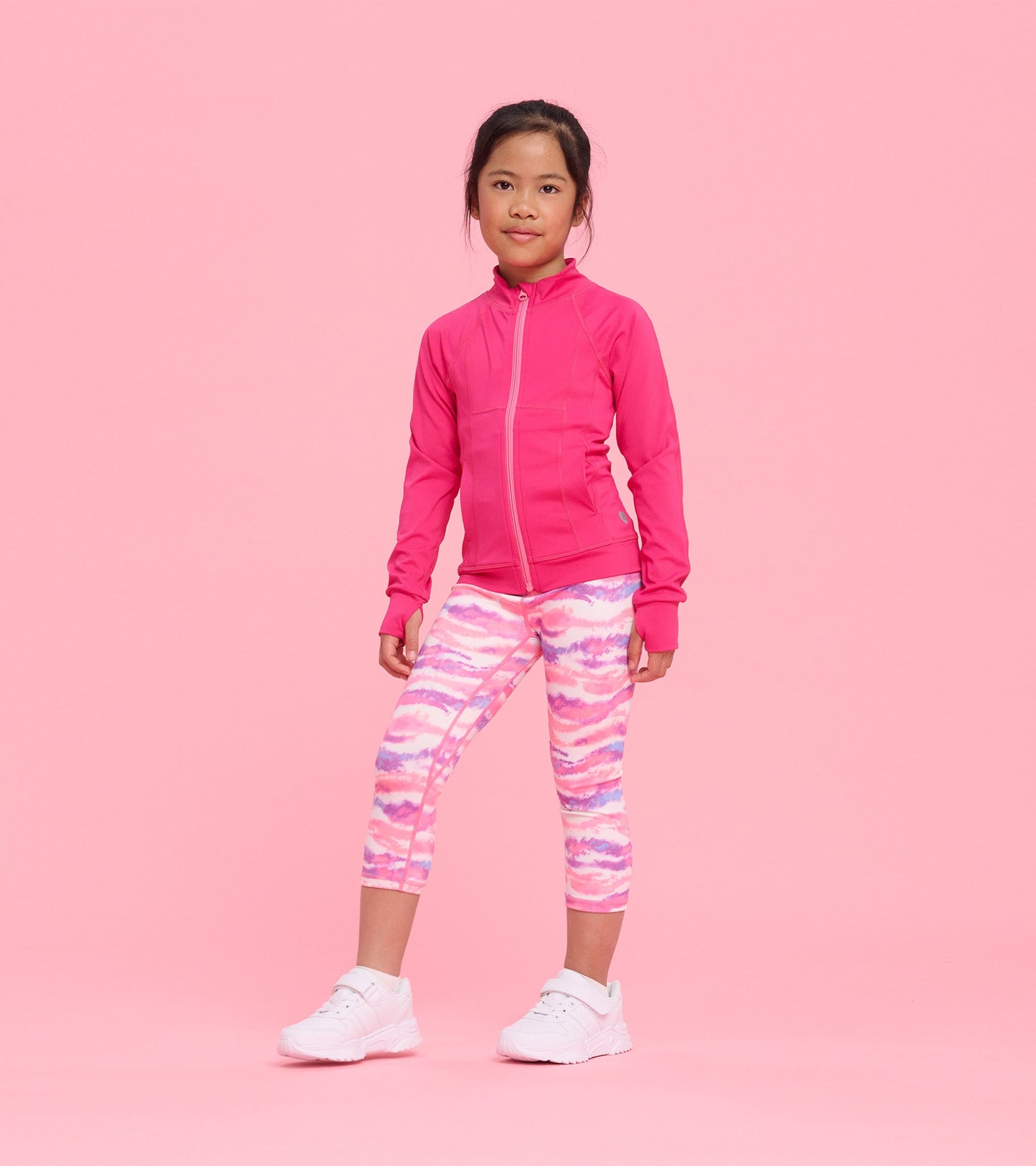 Bright pink active jacket with a zip front, paired with colorful patterned leggings, suitable for active wear.