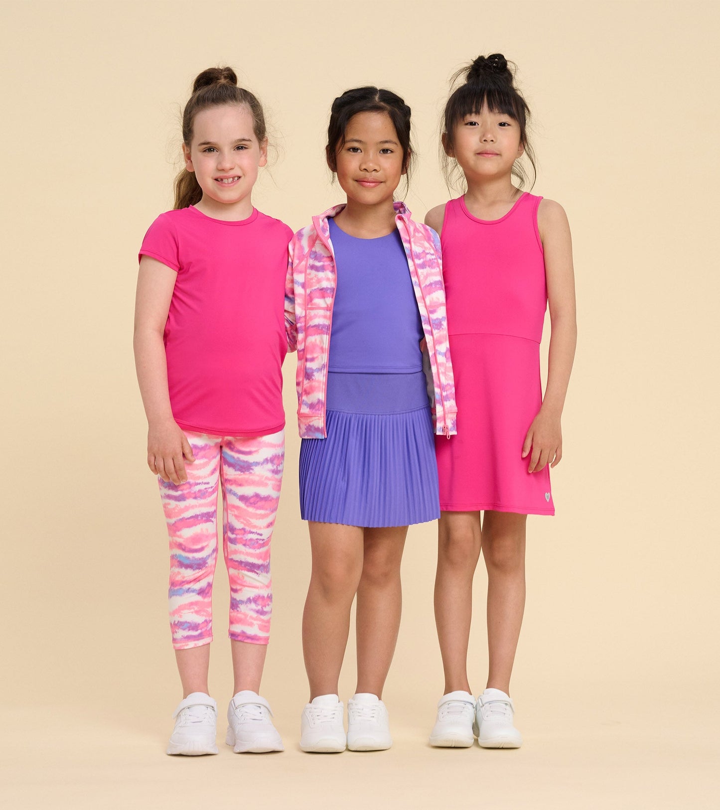 Girls' pink A-line dress with a sleeveless design, paired with colorful activewear, suitable for sports or casual wear.