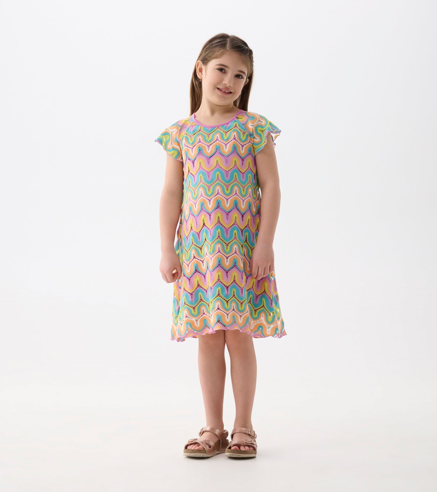 Colorful crochet dress featuring a wavy rainbow pattern and flutter sleeves, perfect for casual wear.