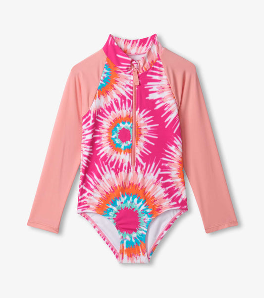 Long sleeve rashguard swimsuit featuring a pink and multicolor sunburst tie-dye pattern with a front zipper.