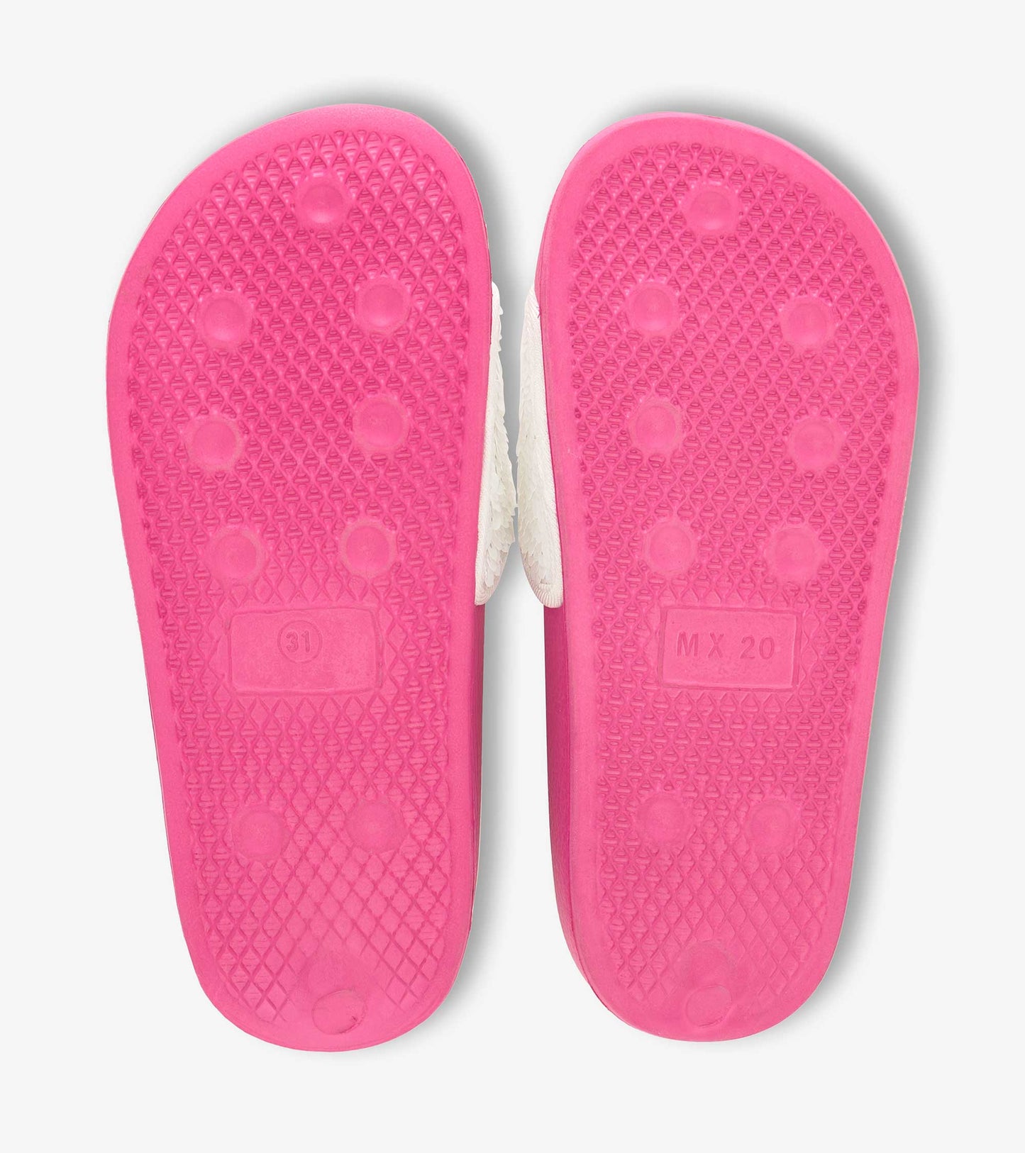 Pink rubber soles of girls' slides featuring a textured grip and white upper with sequin heart accents.