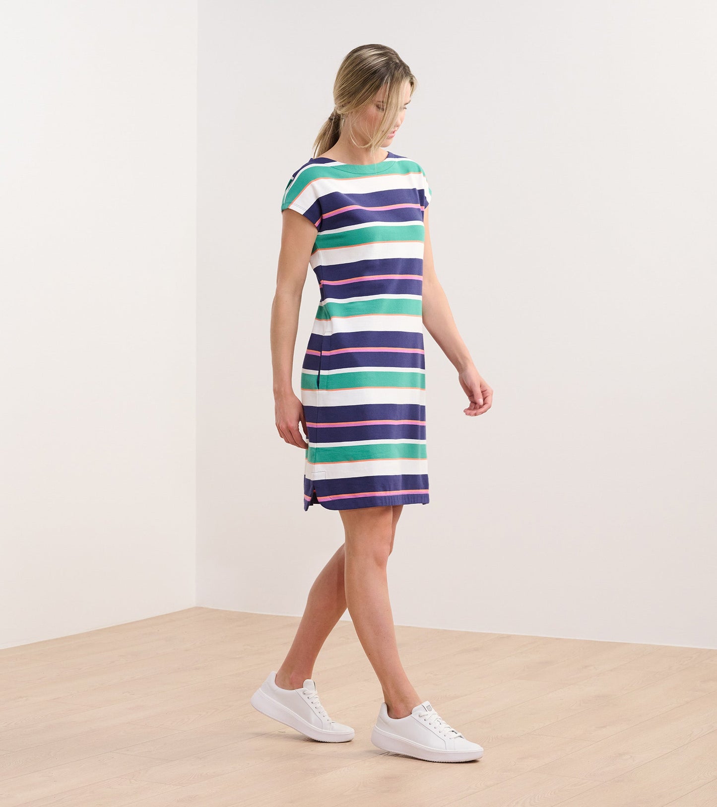 Short-sleeve dress featuring horizontal stripes in green, blue, white, and pink, styled for casual wear.