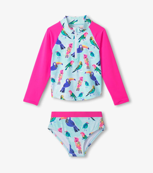 Girls' rashguard set featuring a colorful tropical bird print with a pink long-sleeve top and matching bikini bottom.