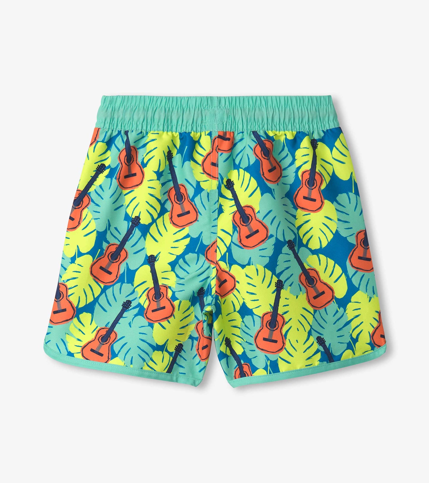 Boys' swim shorts featuring a vibrant tropical pattern of guitars and leaves in blue, green, and yellow colors.