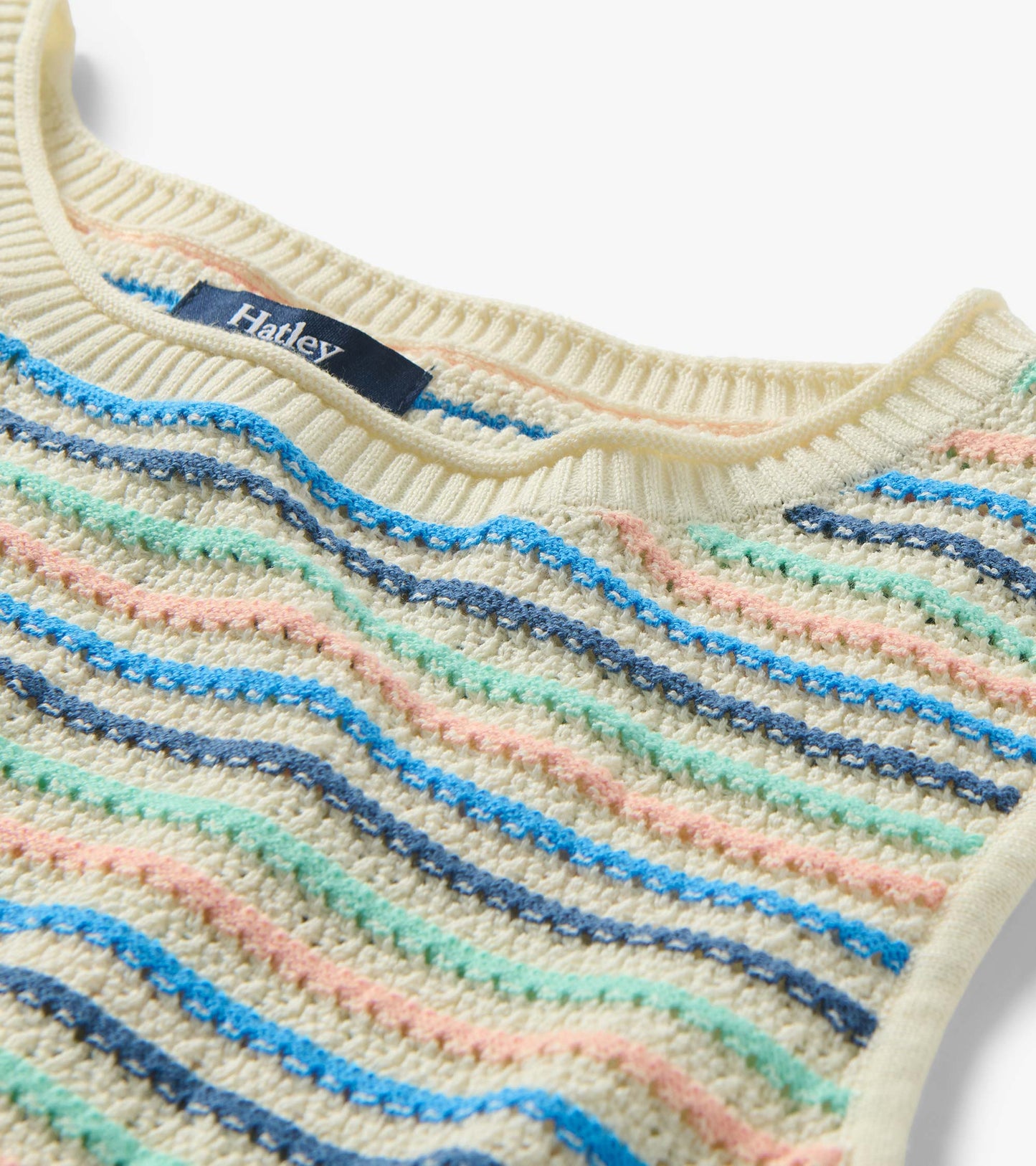 Close-up of ribbed crew neckline and textured knit with blush, aqua, and blue stripes