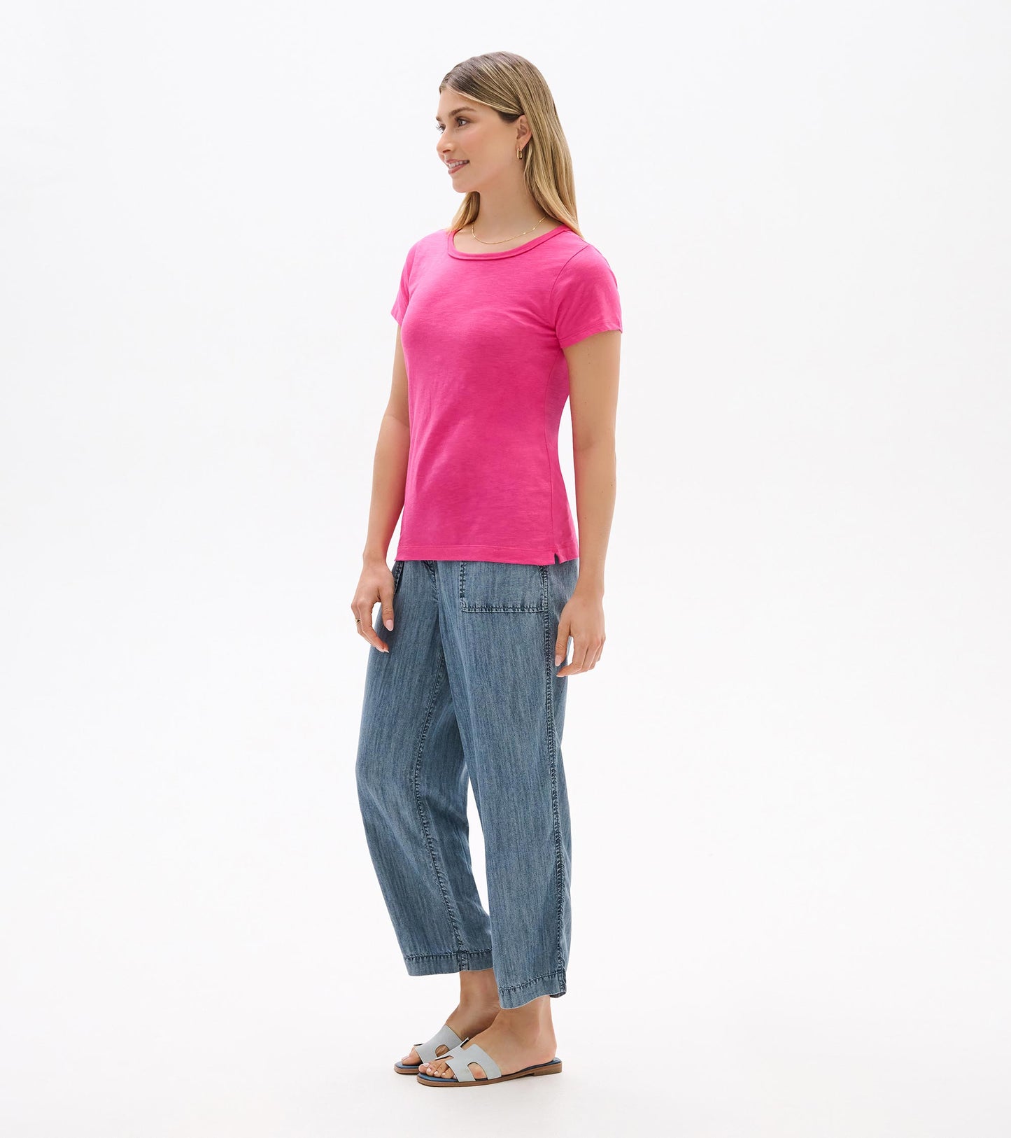 Women's bright pink crew neck short sleeve tee shown from the front on a model