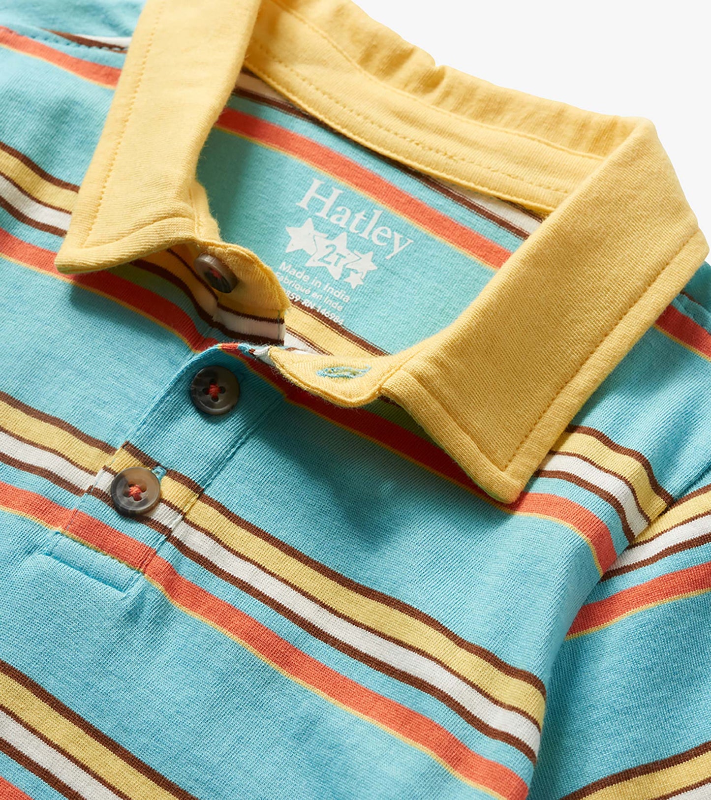 Close-up of a turquoise striped toddler polo shirt with yellow collar and button placket