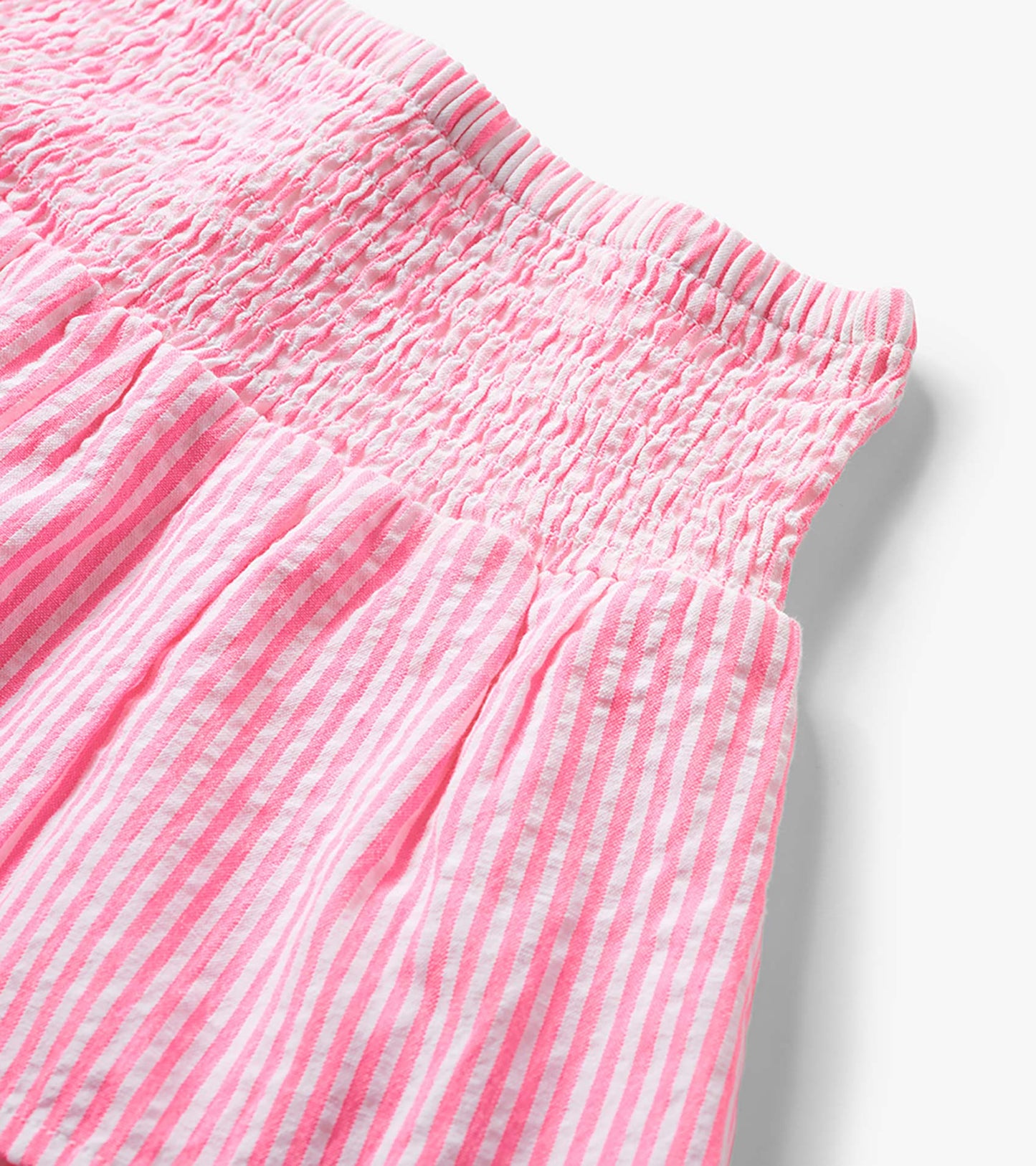 Neon pink and white striped seersucker skirt with smocked waistband and gathered fabric