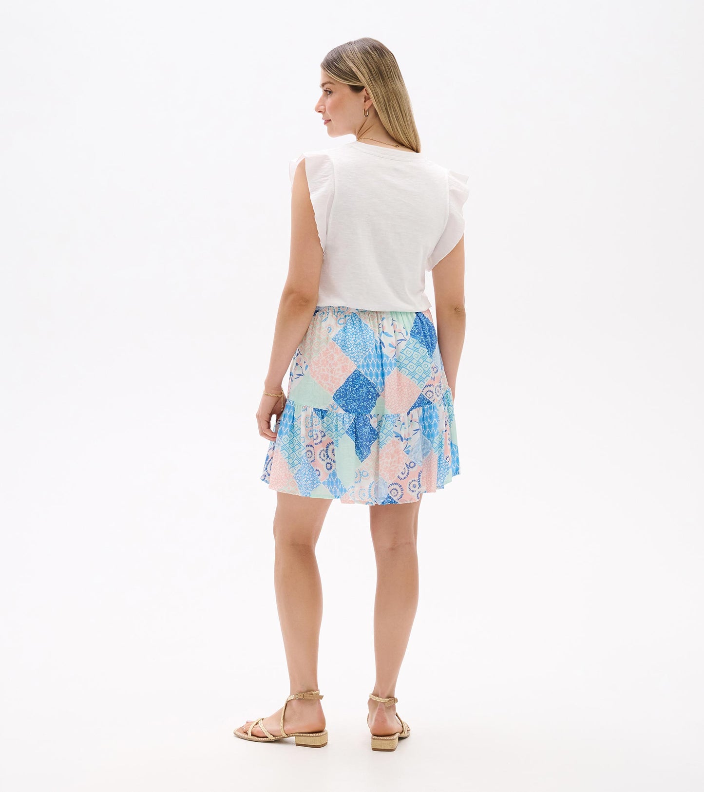 Back view of a pastel blue, pink, and mint patchwork flounce skirt with layered ruffle hem.