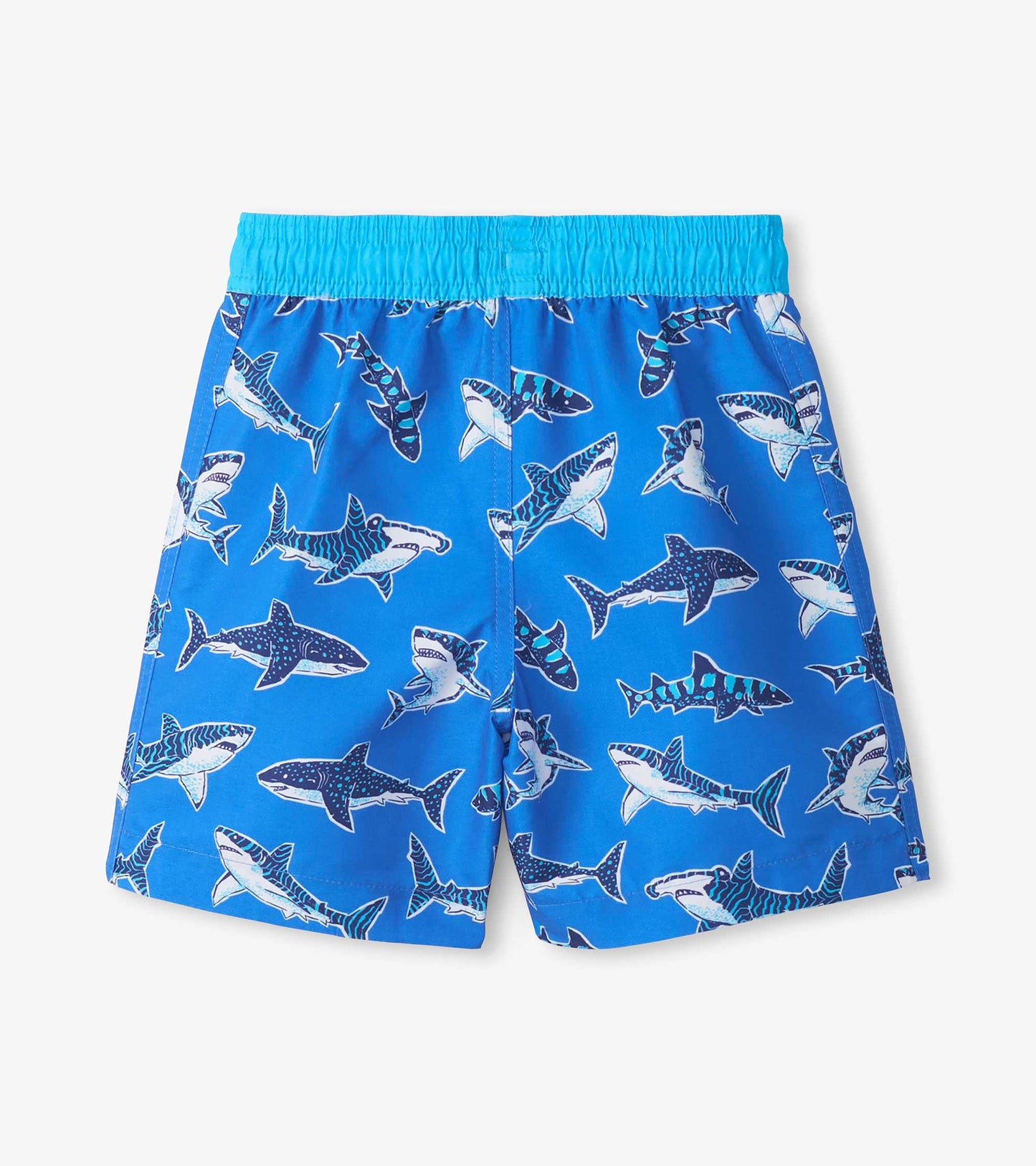 Blue boys swim trunks with shark print and light blue elastic waistband, front view