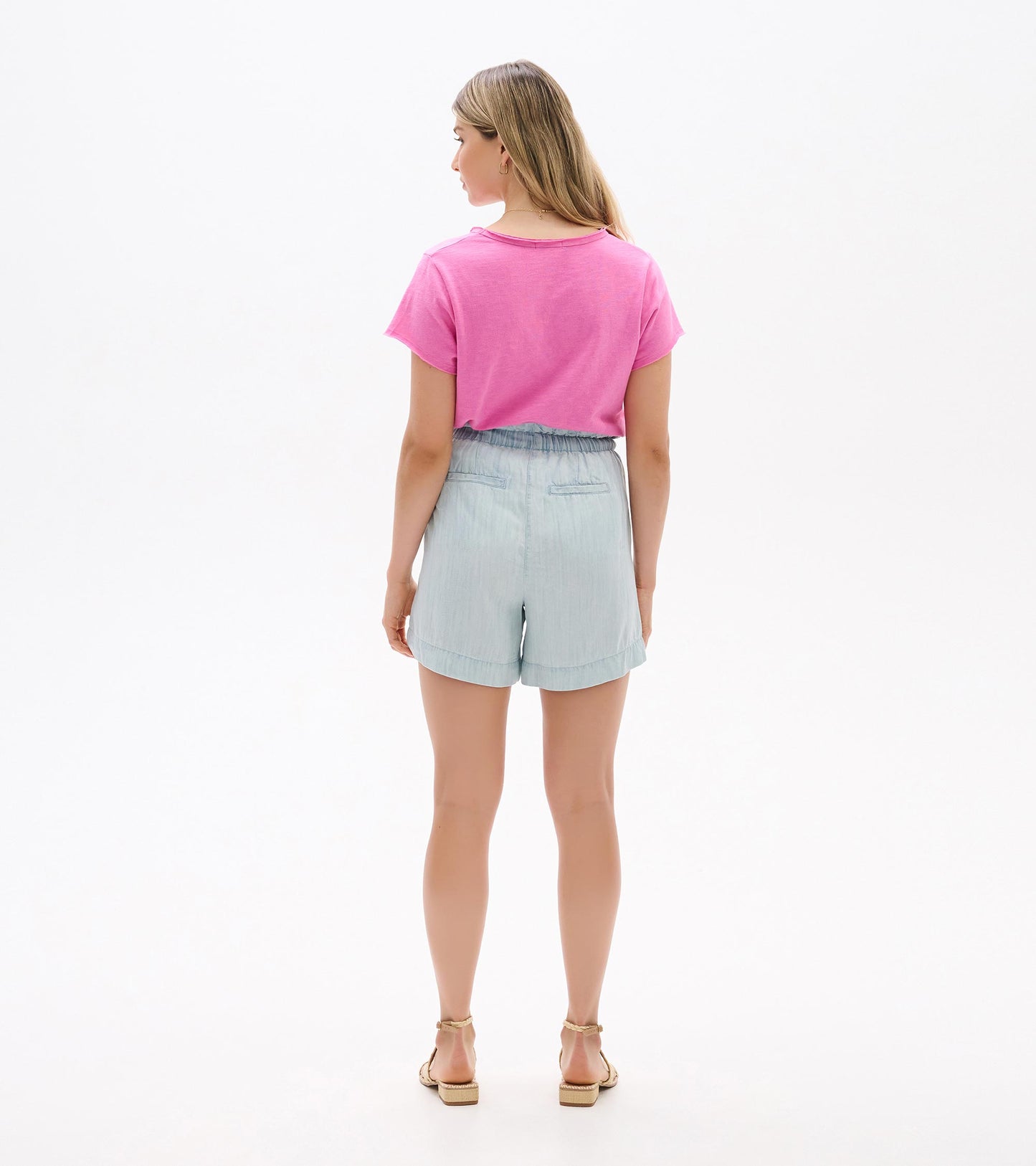 Light blue high-waisted shorts with elastic waistband and rolled hem, back view