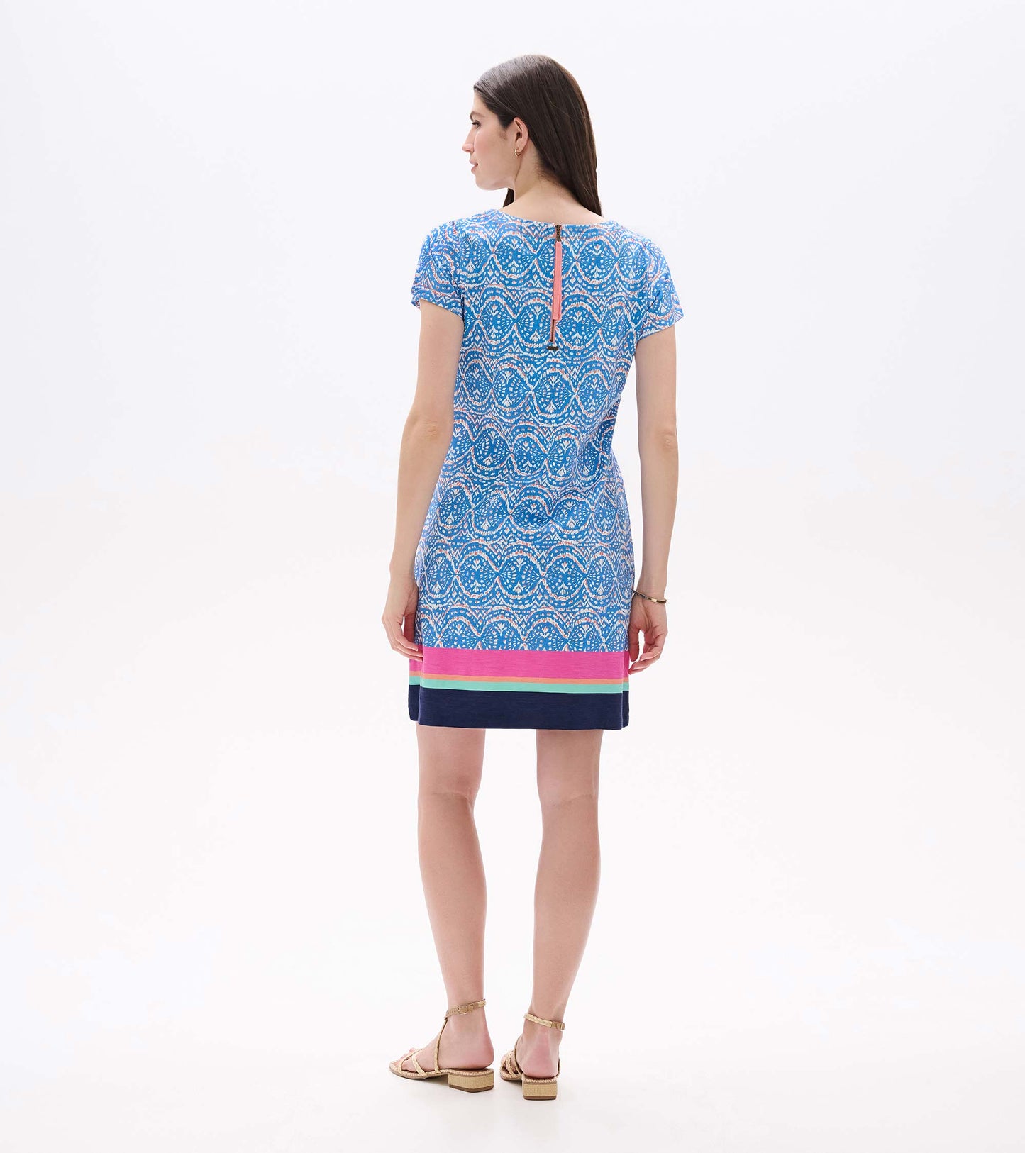 Back view of blue and white ikat tee dress with short sleeves, back zipper, and striped border hem