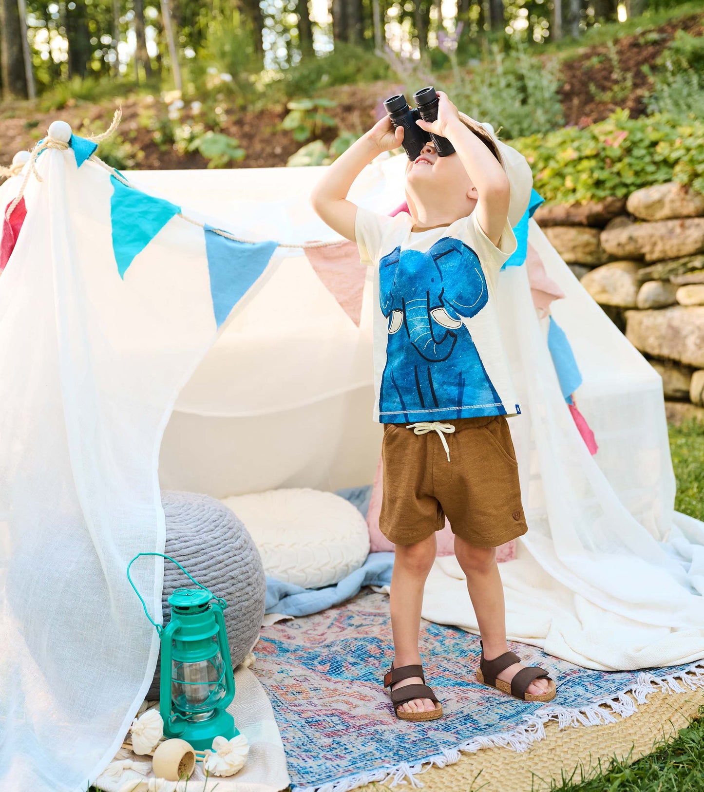 Toddler boy wearing brown pull-on shorts with white drawstring, front view