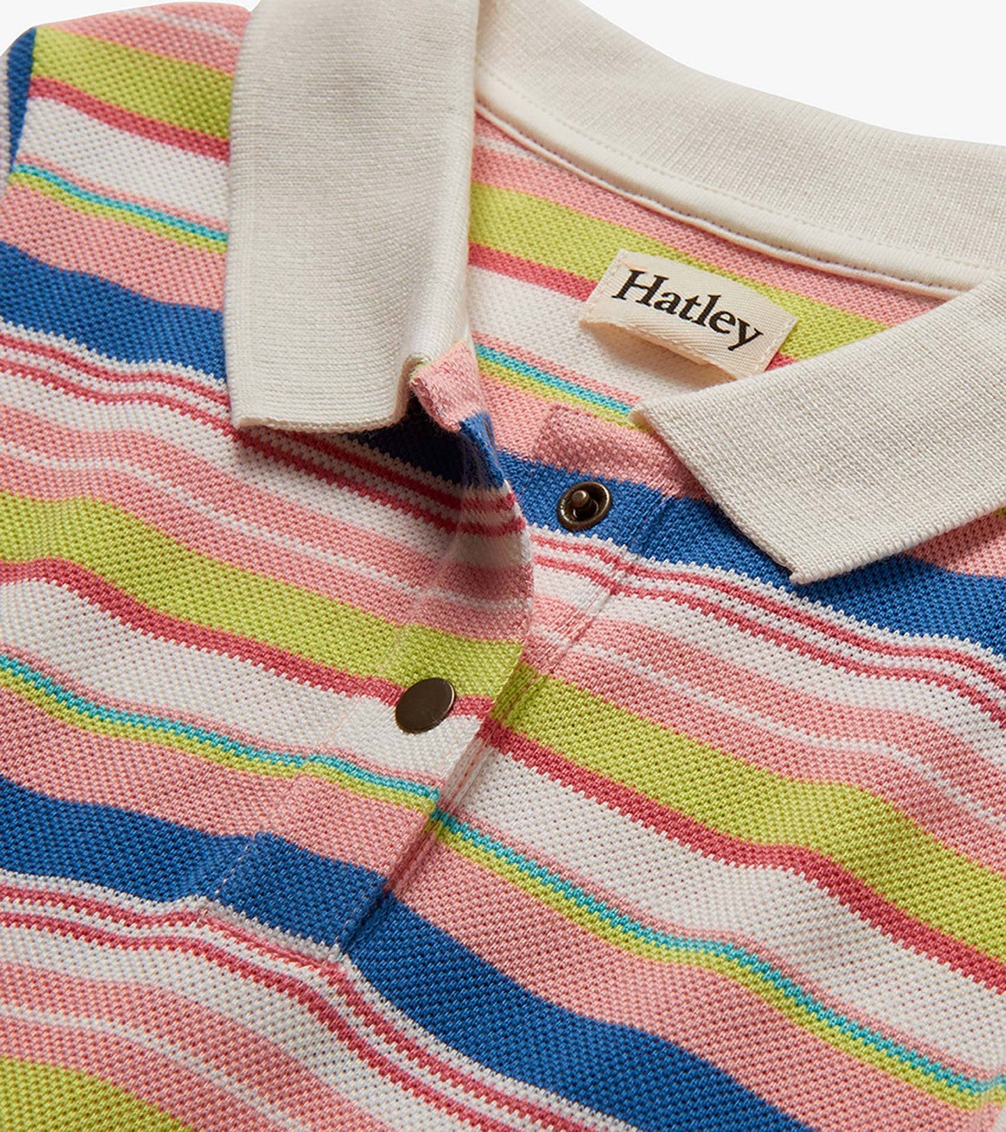 Close-up of a striped pique polo dress with white collar and snap buttons in pink, blue, green, and white.
