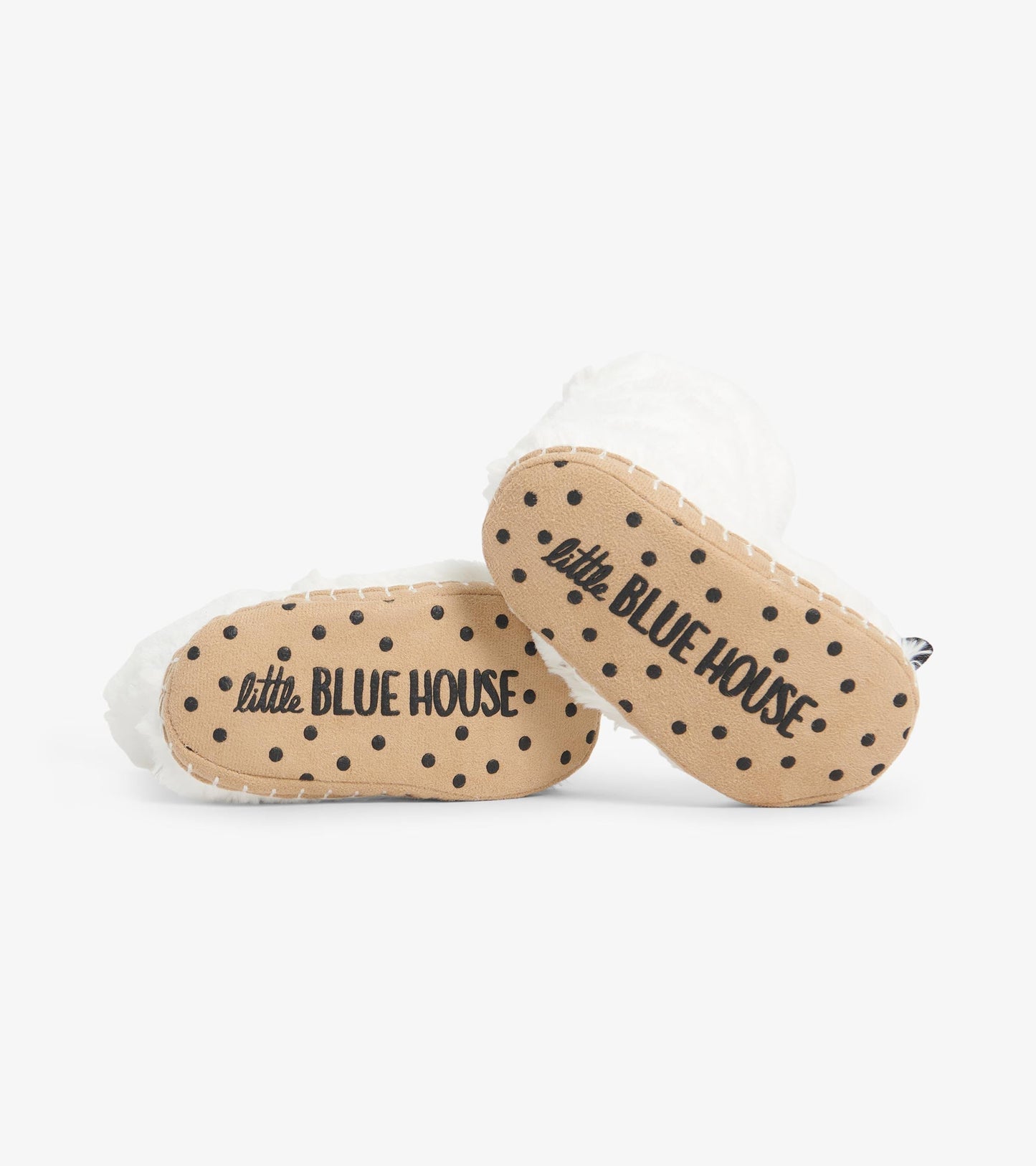 White polar bear paw slippers with a soft texture and dotted tan soles, ideal for kids' indoor wear.