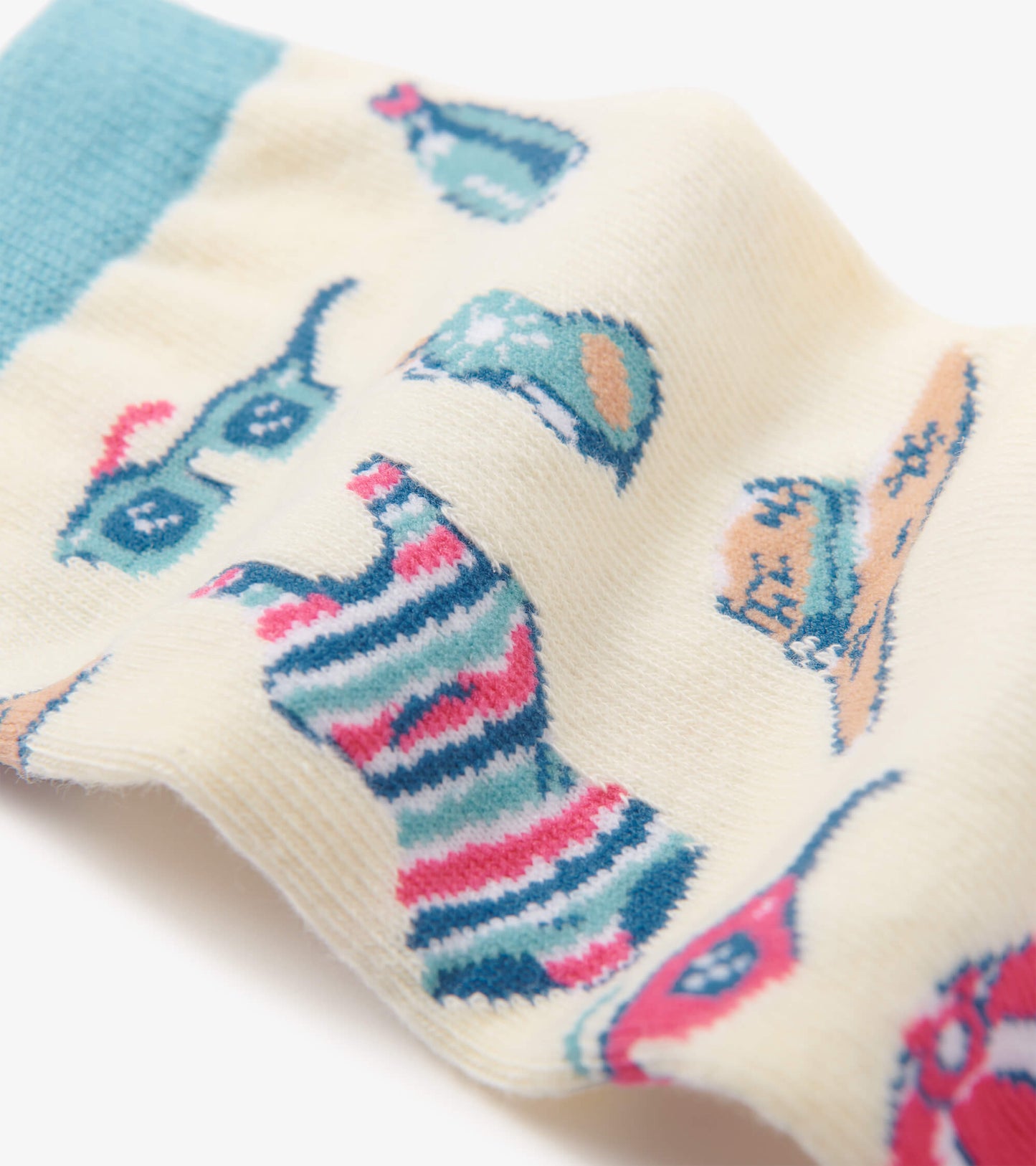 Cream crew socks featuring colorful beach-themed patterns, including sunglasses, drinks, and striped designs.