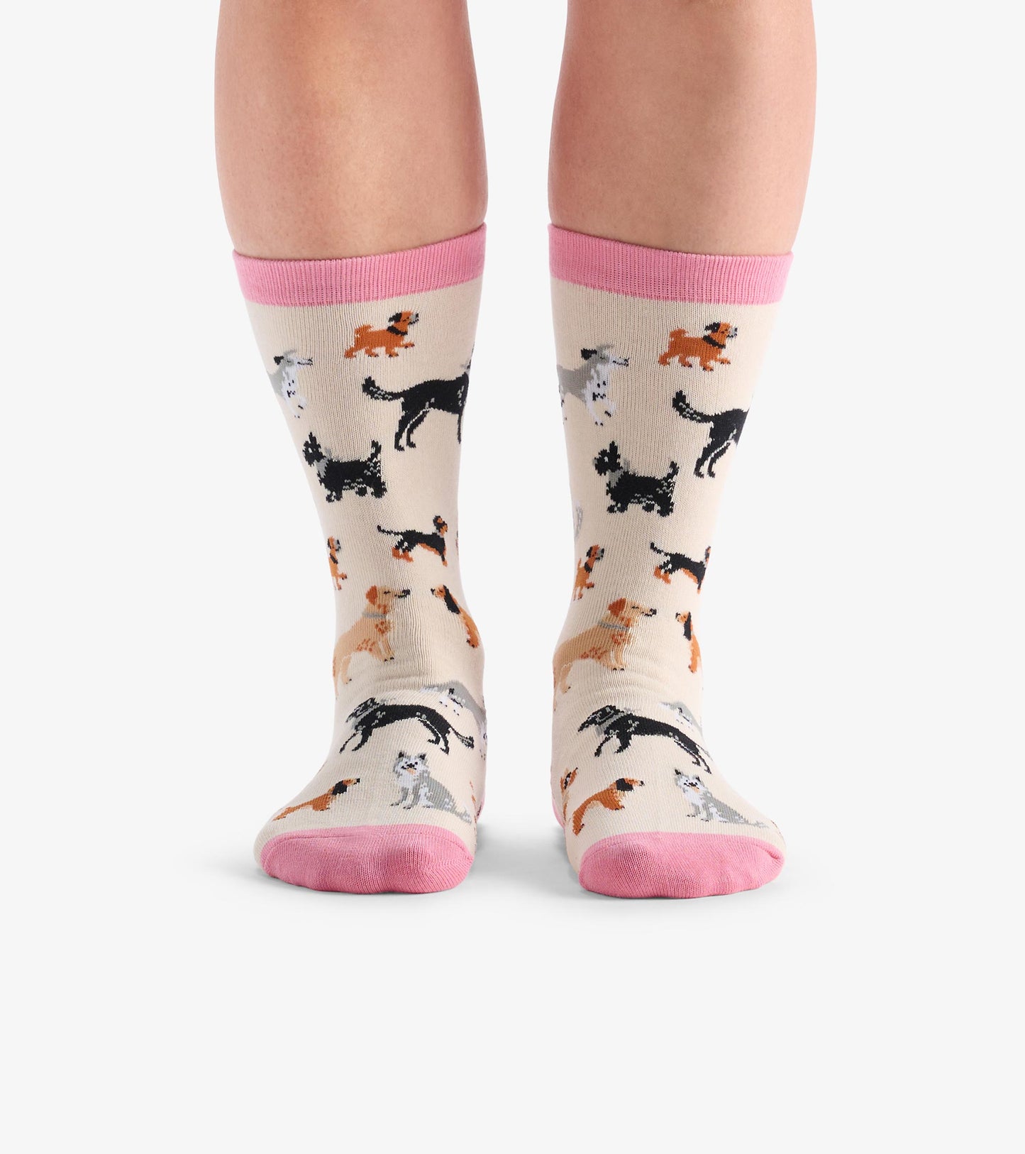 Beige crew socks featuring a playful pattern of various dog breeds with pink cuffs. One size fits most.