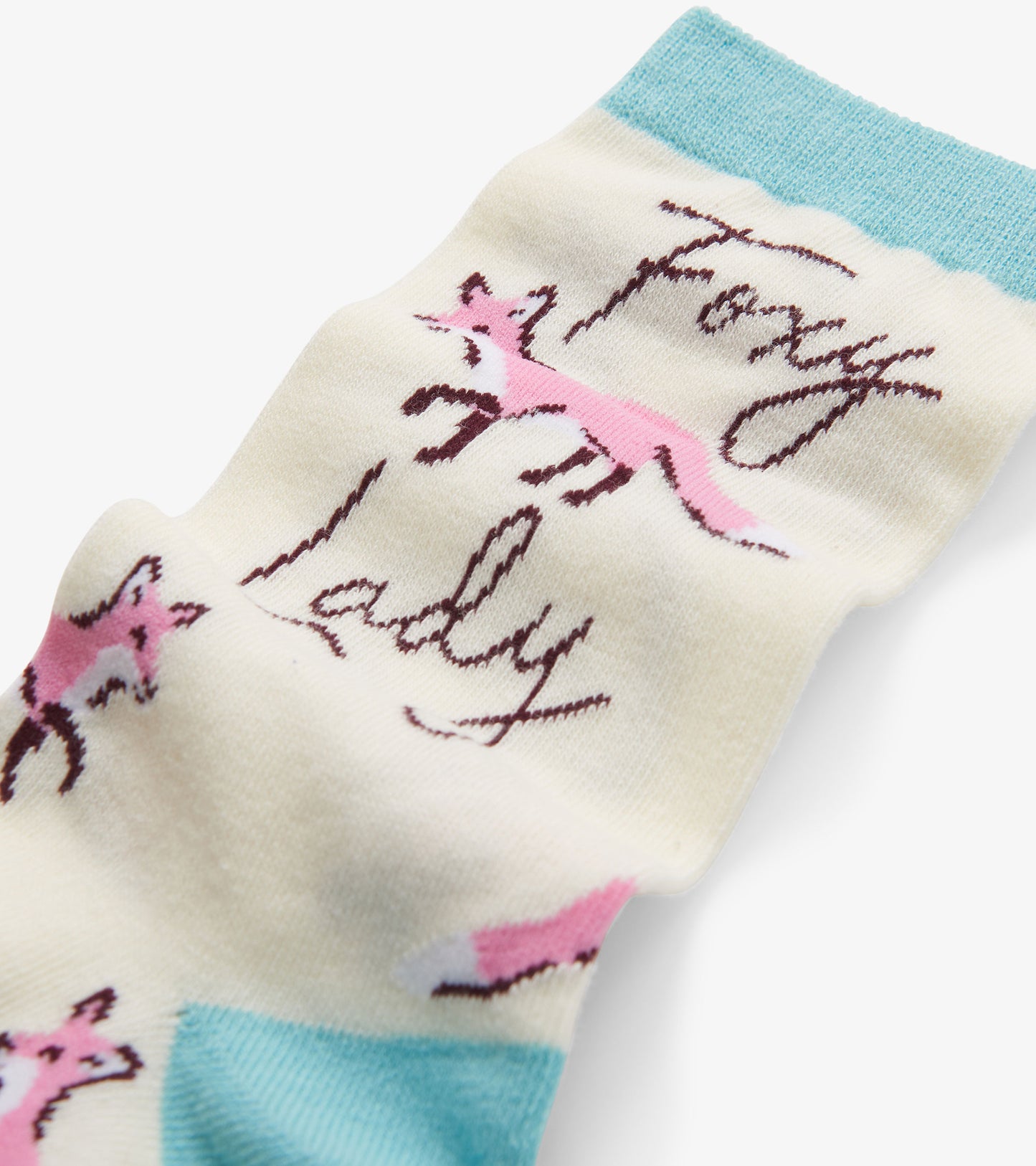 Cream socks with pink fox illustrations and "Foxy Lady" text, featuring a light blue cuff. One size fits all.