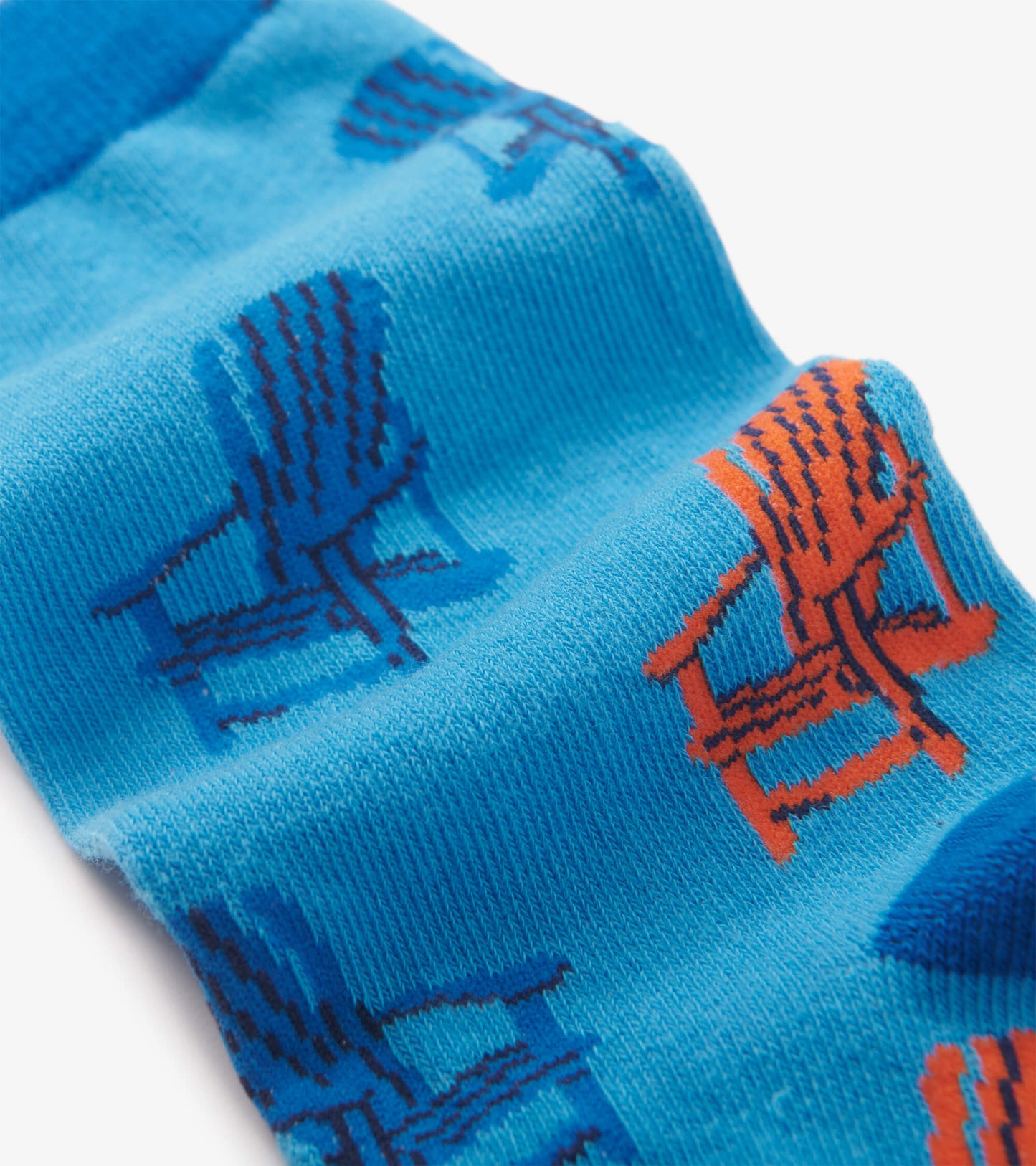 Blue crew socks featuring a pattern of orange and blue Muskoka chairs. Soft knit material, suitable for casual wear.