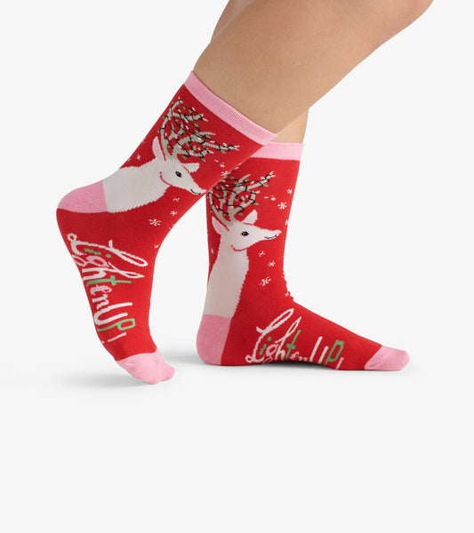 Red crew socks featuring white deer with antlers, pink accents, and "Lighten Up" text, ideal for casual wear.