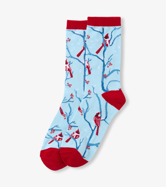 Light blue crew socks featuring red cardinals and branches, with red cuffs and toes, perfect for winter wear.