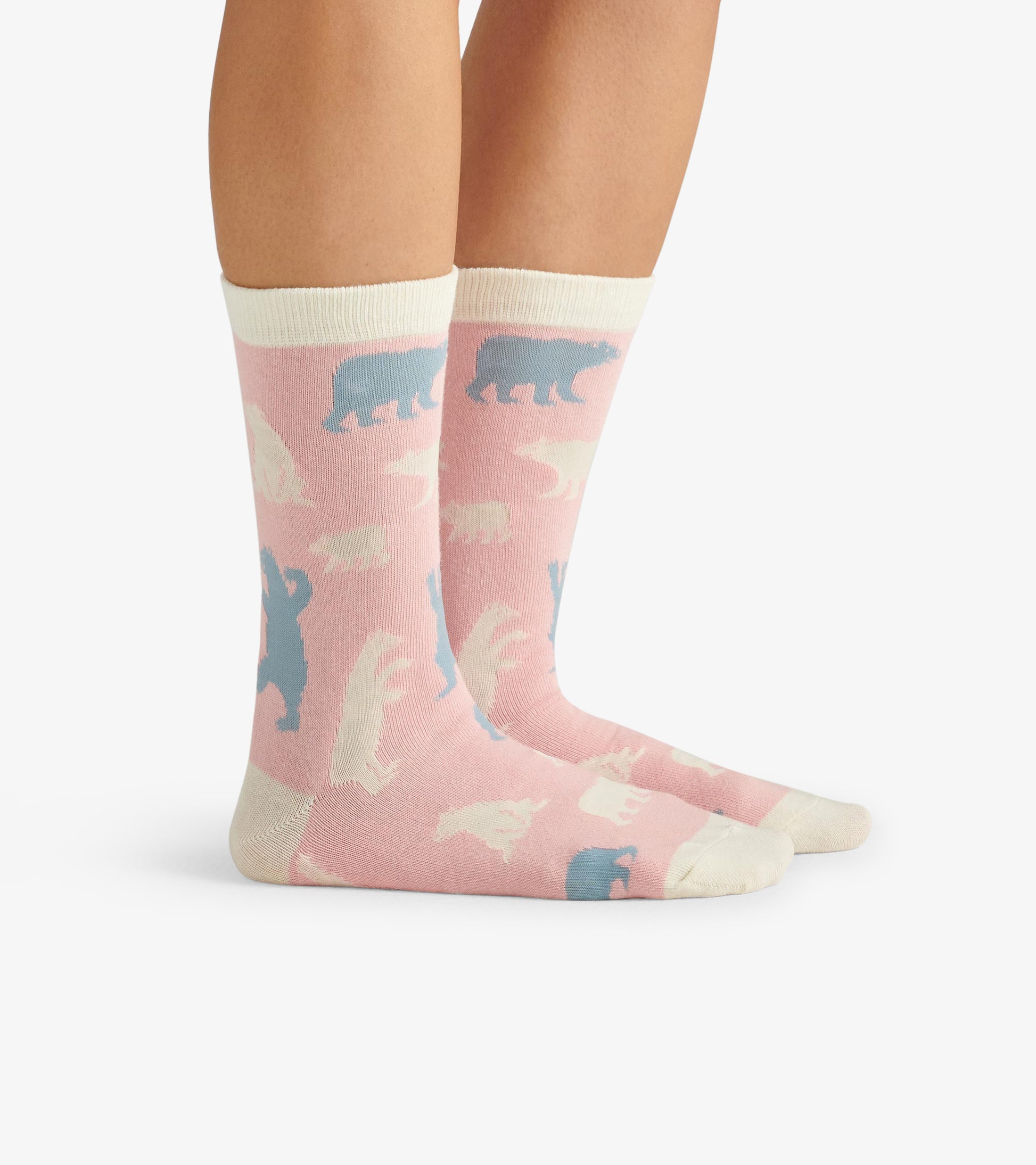 Pink crew socks featuring polar bear patterns in white and blue, with a contrasting cream cuff. One size fits most.