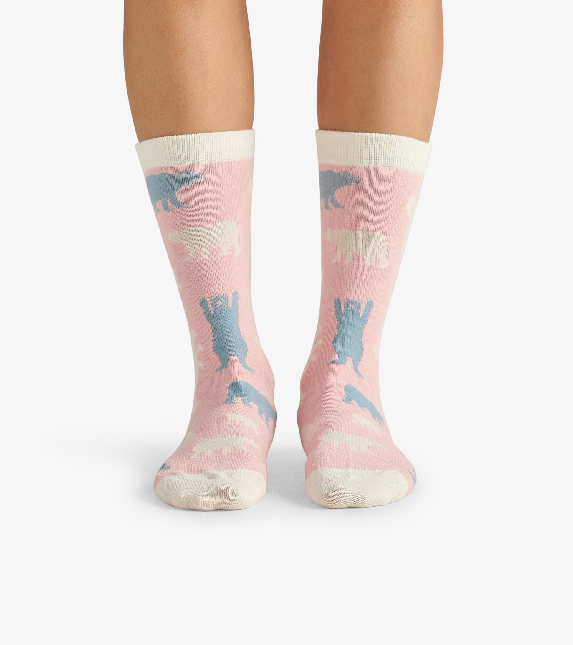 Pink crew socks featuring polar bear patterns in blue and white, with a contrasting white cuff. One size fits all.