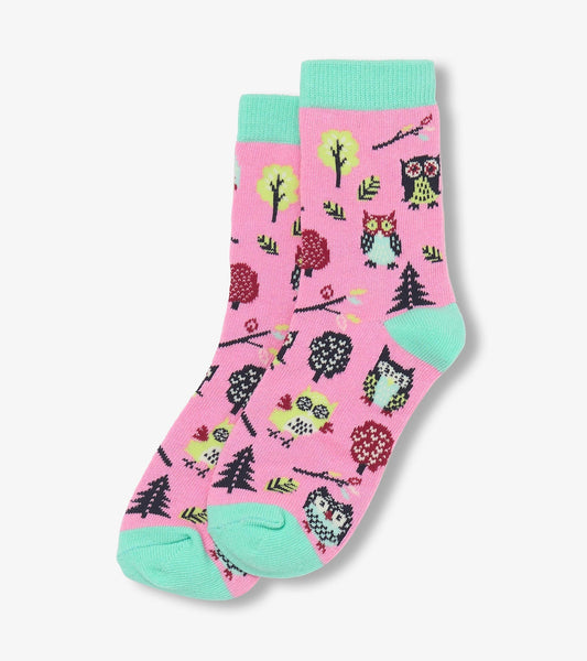Pink crew socks featuring colorful owl and tree patterns with mint green cuffs and toes. Ideal for kids.