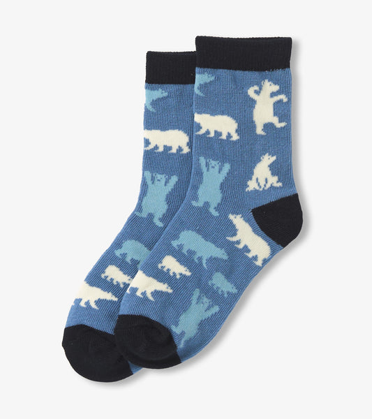 Blue crew socks featuring polar bear patterns in light blue and white, with a black cuff and toe.