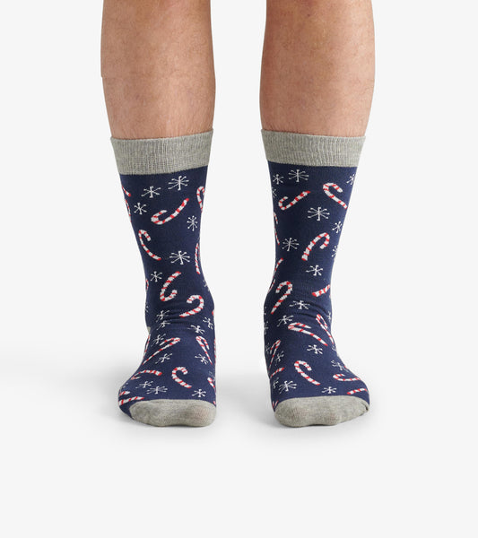 Navy crew socks featuring a candy cane pattern and snowflakes, with a light gray cuff. One size fits most.