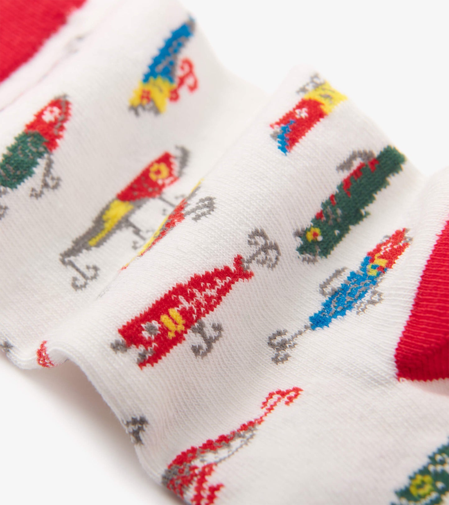 White crew socks featuring colorful fishing lure patterns and a red cuff. Suitable for casual wear.