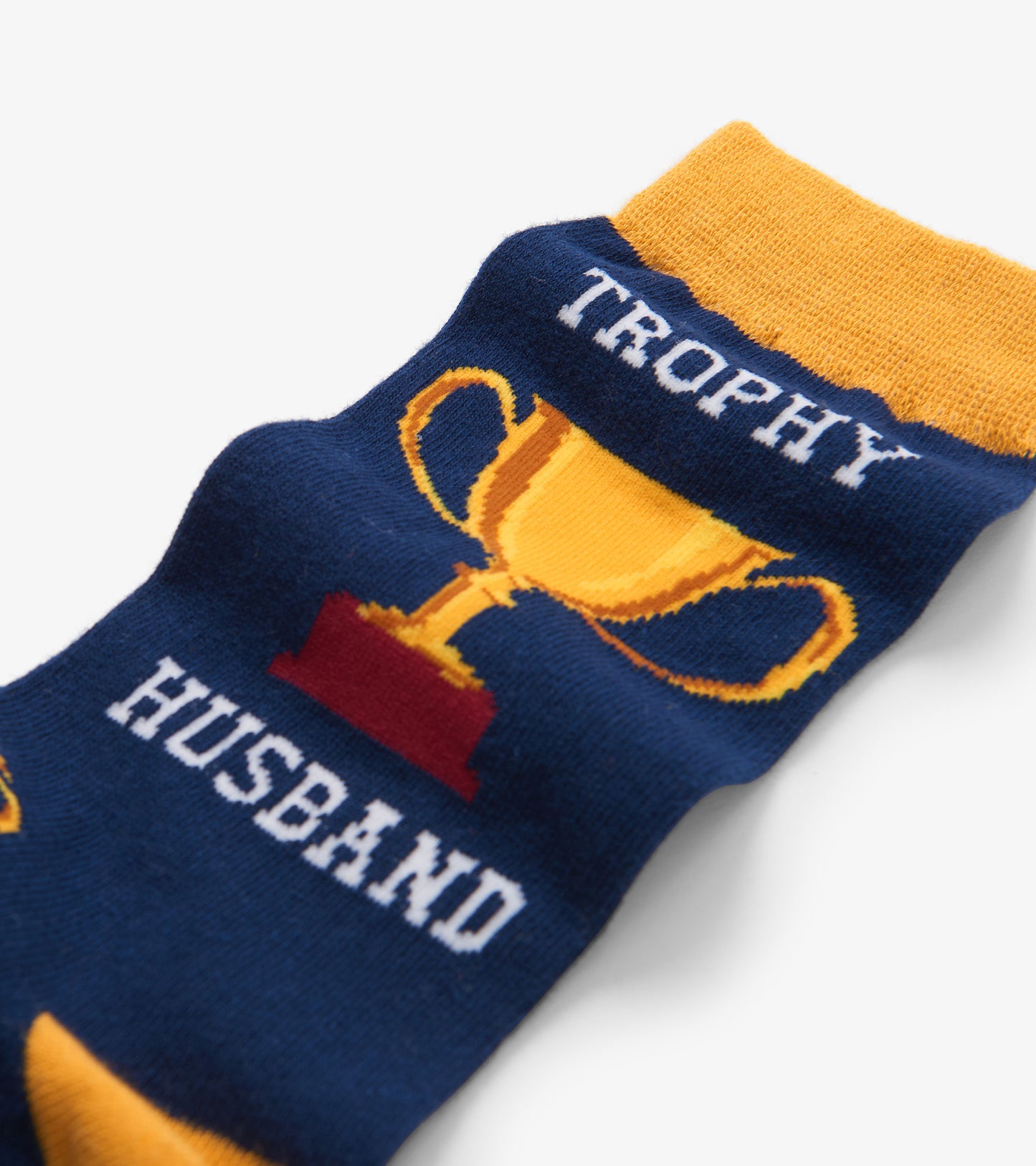 Navy crew socks featuring a trophy graphic and the text "TROPHY HUSBAND" in white and yellow. One size fits all.