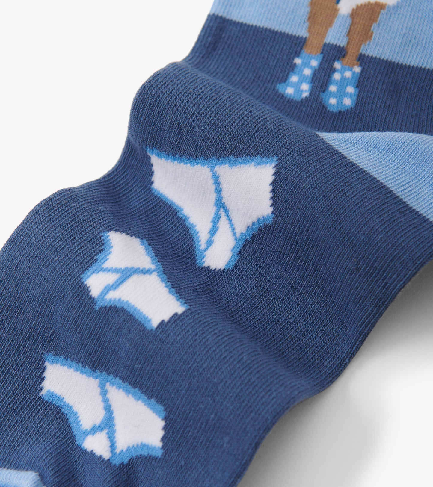 Close-up of blue sock foot with white briefs pattern and light blue toe detail