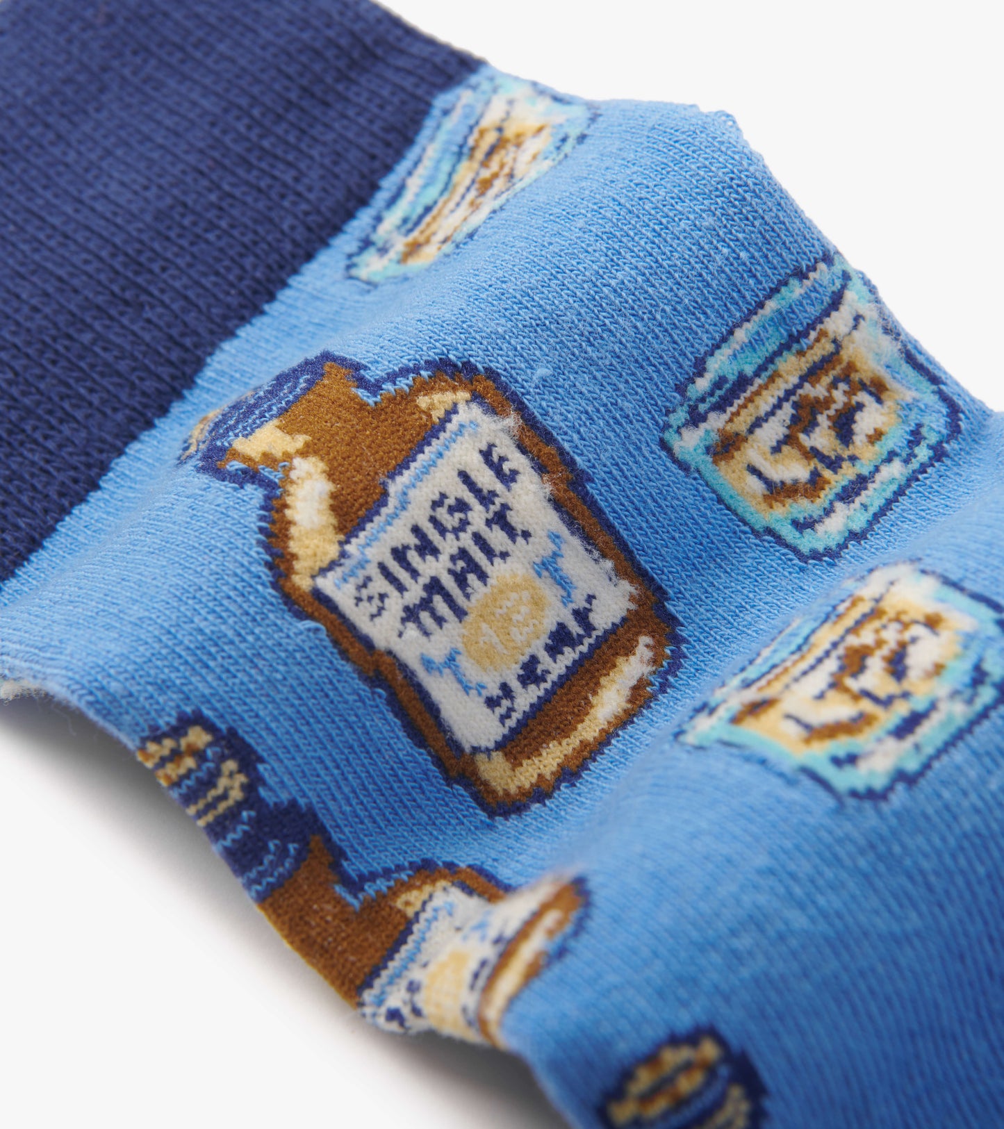 Blue crew socks featuring a playful whiskey bottle pattern on a light blue background with a dark blue cuff.